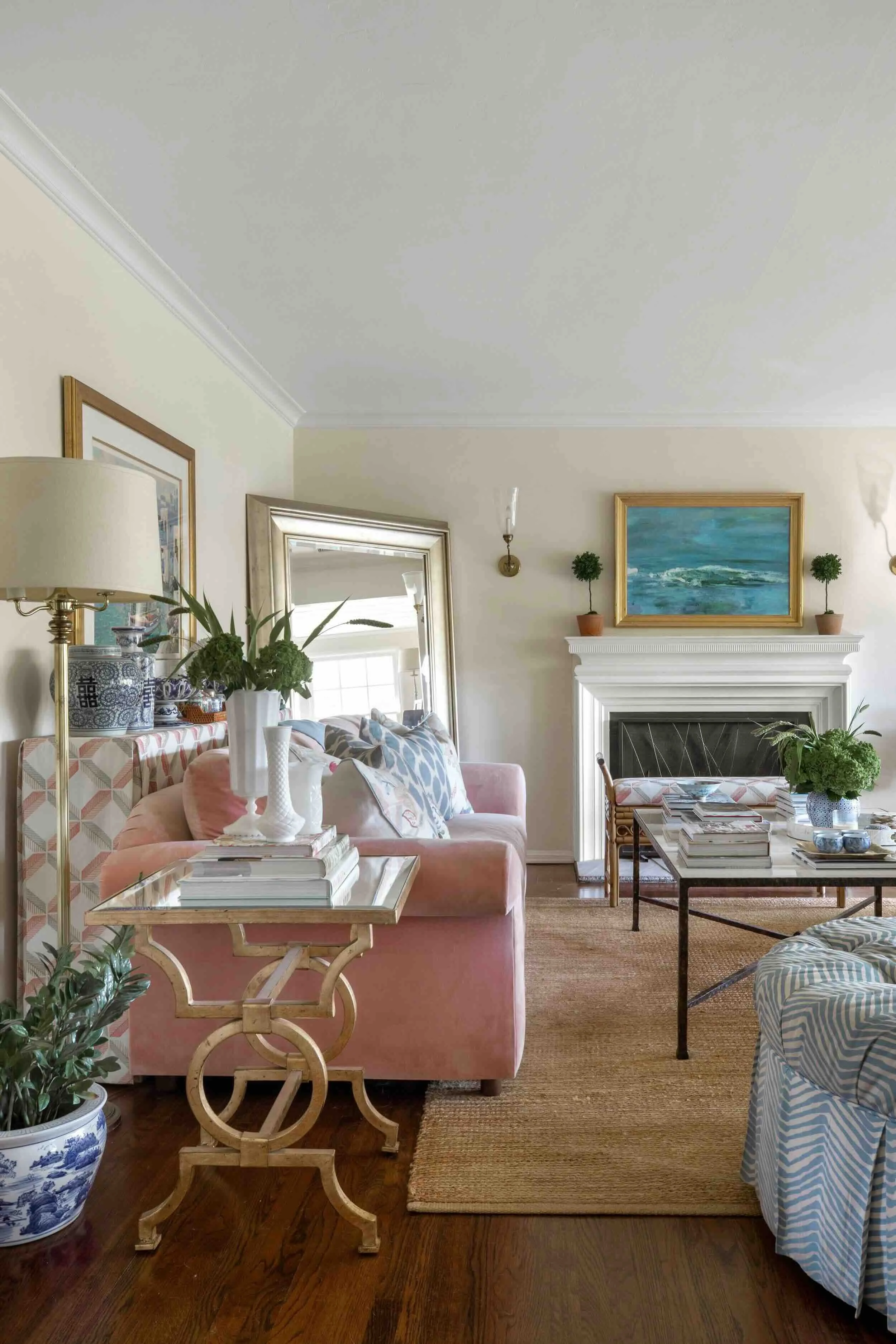 Layered living room combining traditional furniture, natural materials, artwork, and collected accessories by JKB Home Design
