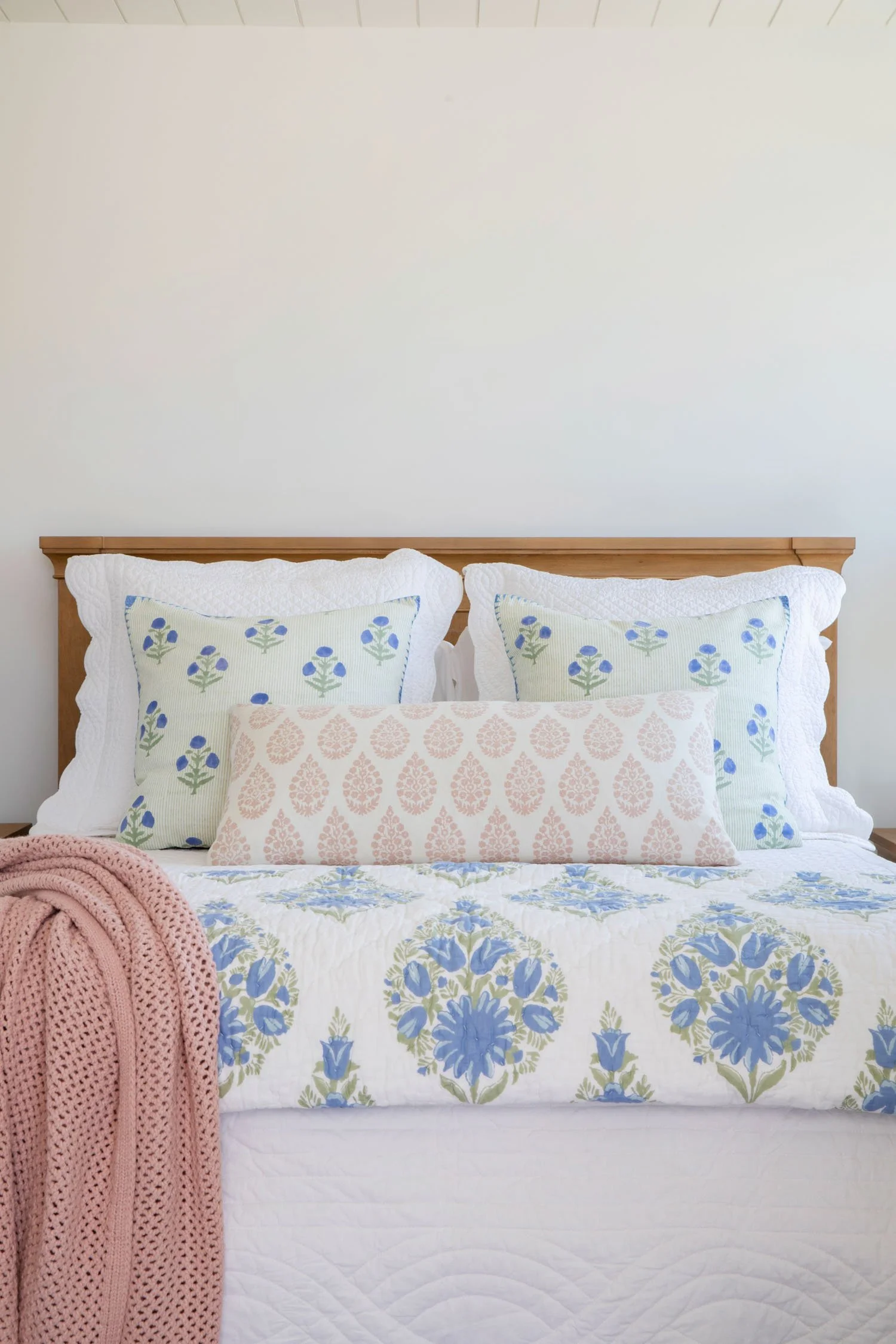Refined coastal bedroom with layered blue and white textiles and ocean-inspired artwork in Manhattan Beach by JKB Home Design