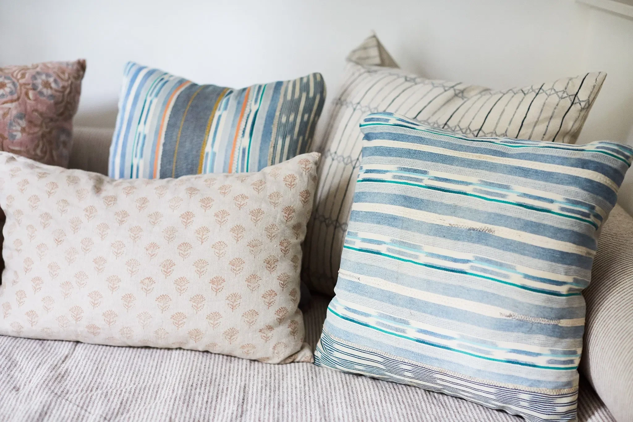 Custom blue and neutral patterned pillows made with globally inspired textiles in a San Anselmo guest room