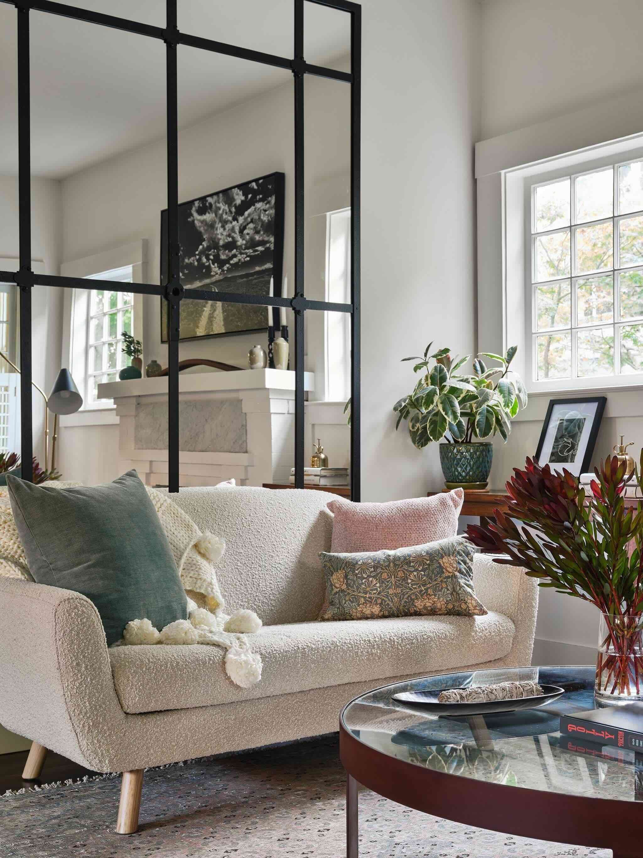 Layered San Anselmo living room with boucle sofa, patterned pillows, oversized industrial mirror, and white fireplace