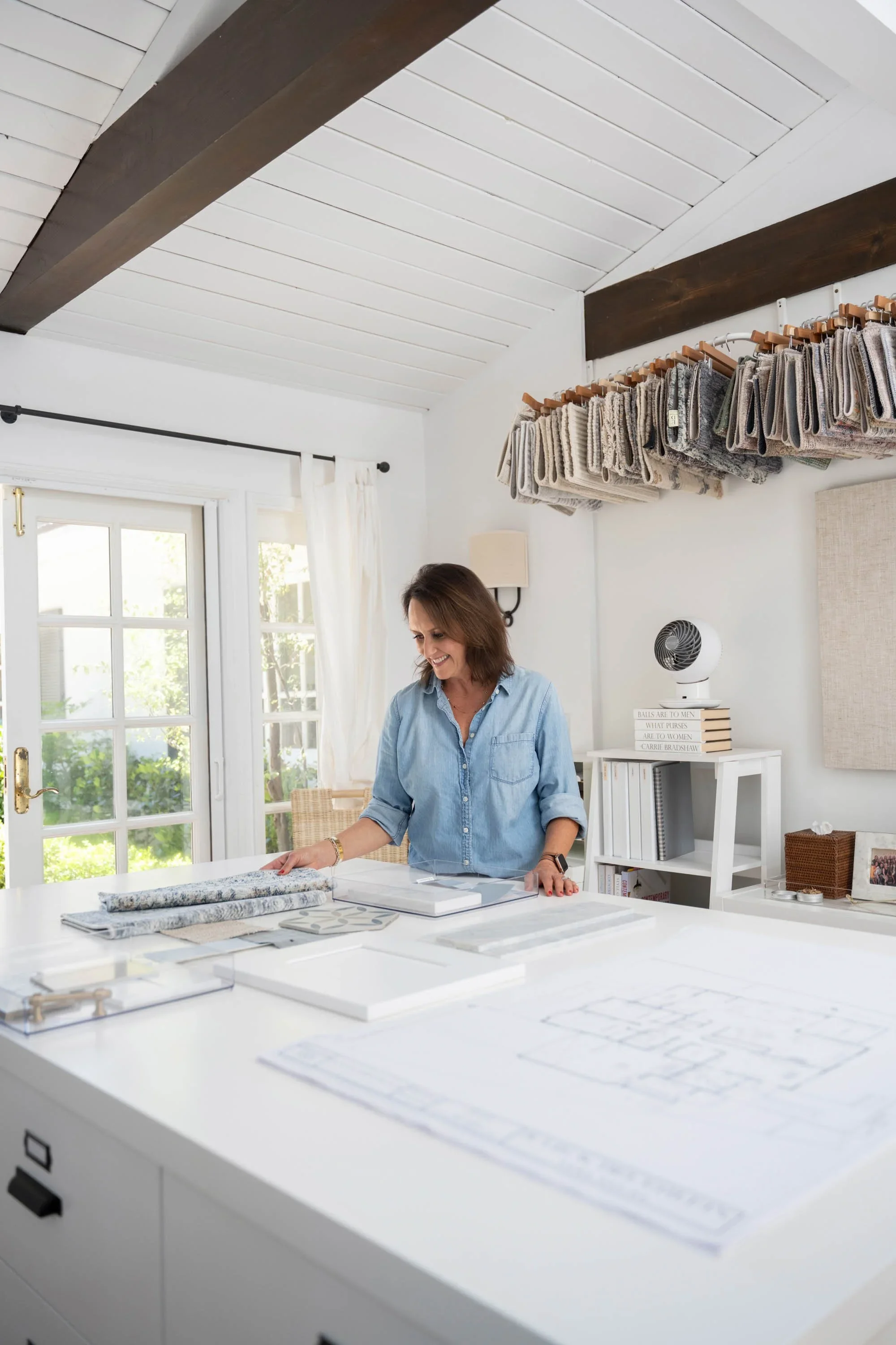 Full-service interior designer Julie Beuerlein in her Palos Verdes design studio reviewing materials