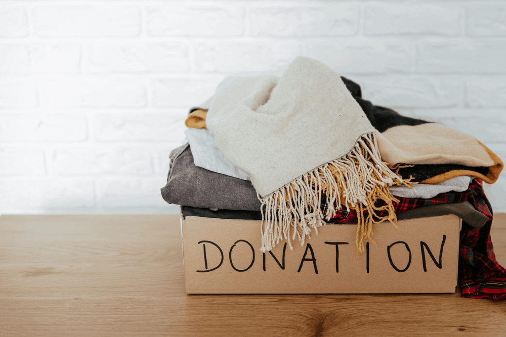 Box of clothing ready for donation as part of a spring home decluttering project