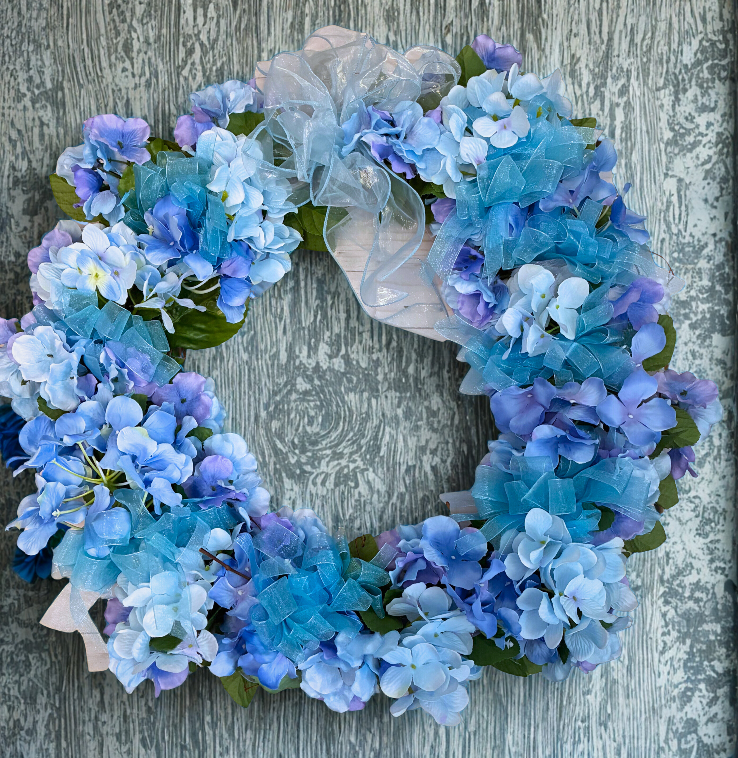 blue hydrangea rustic gray wall.png