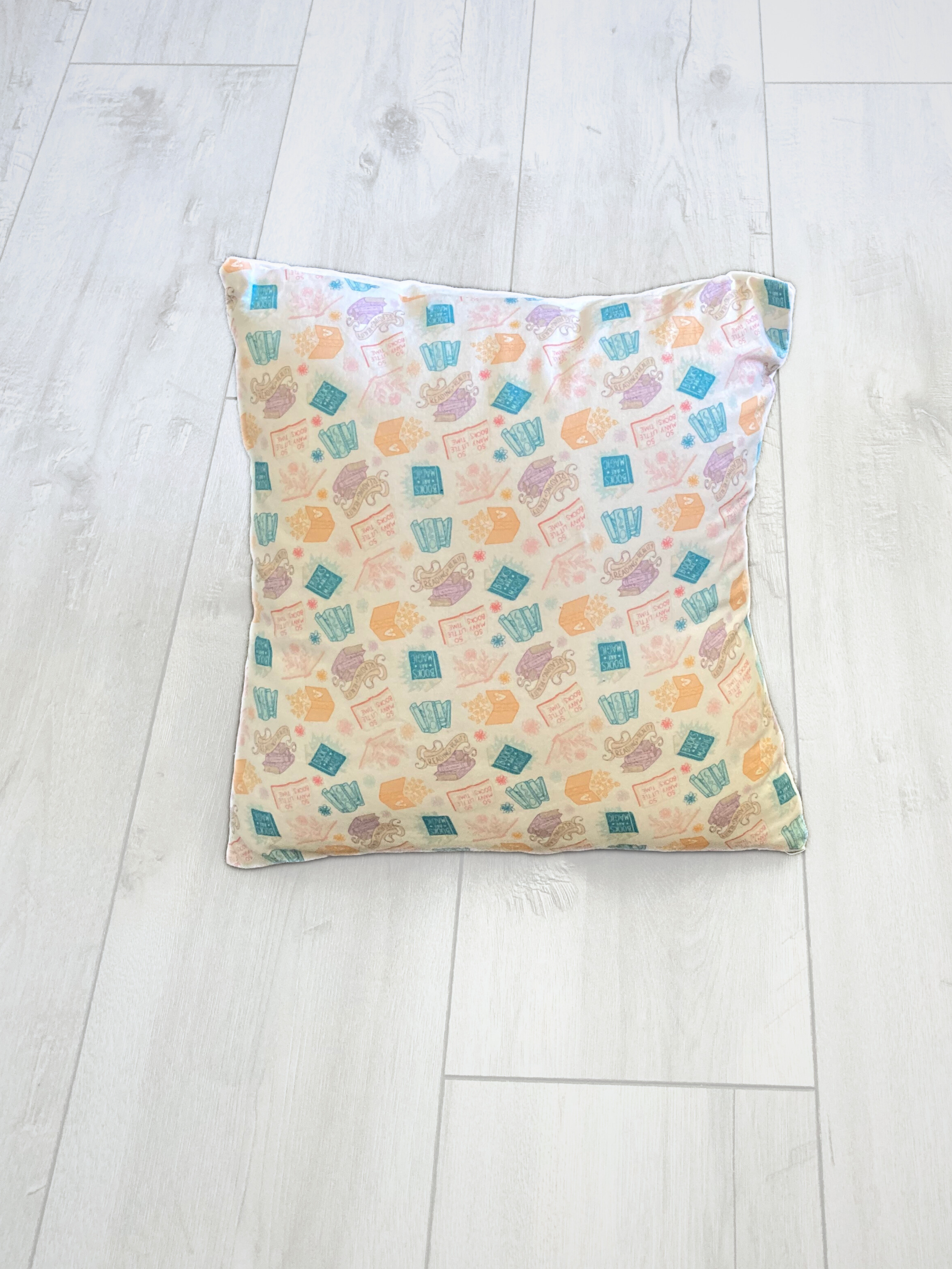 pastel books pillow.png