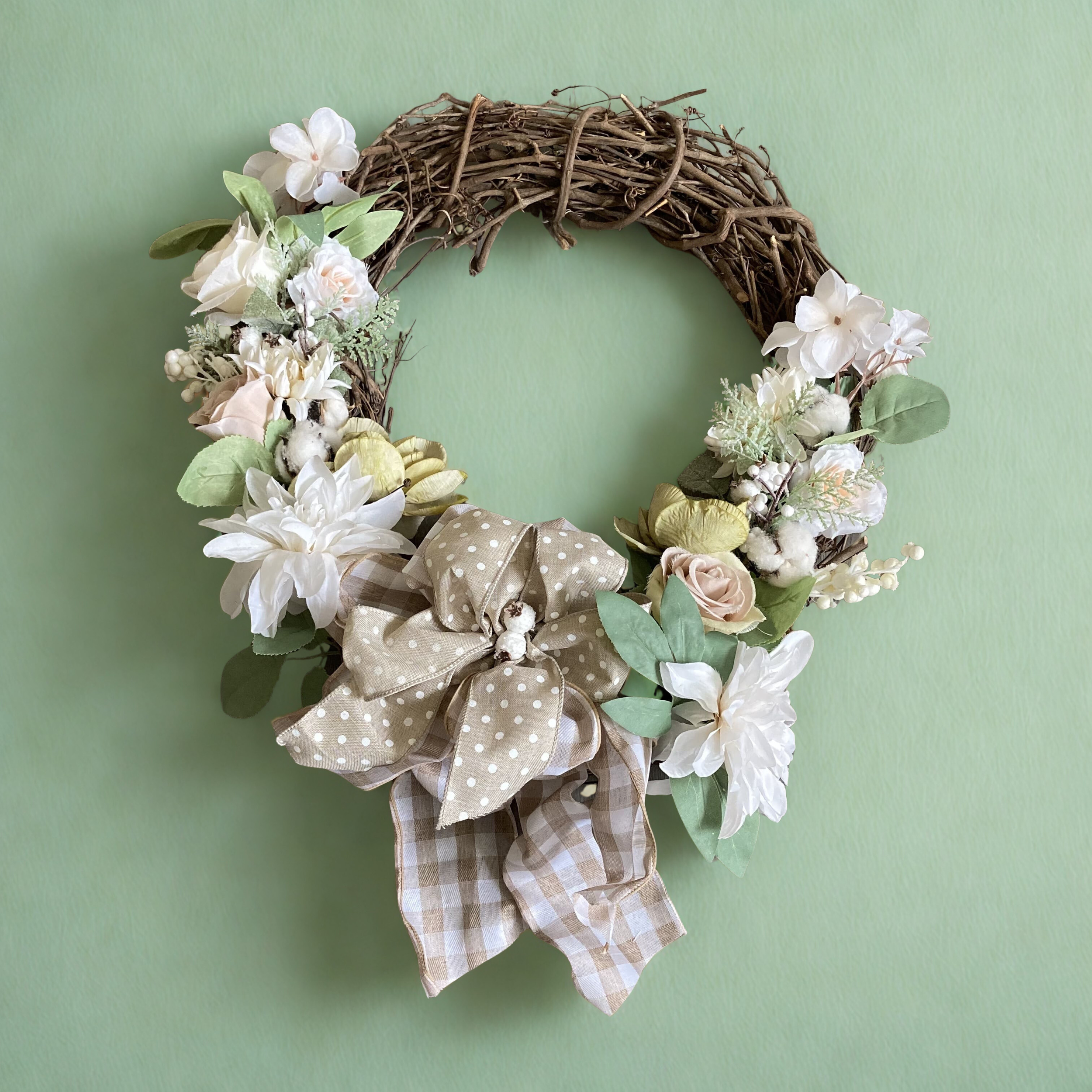 neutral wreath on green wall.png