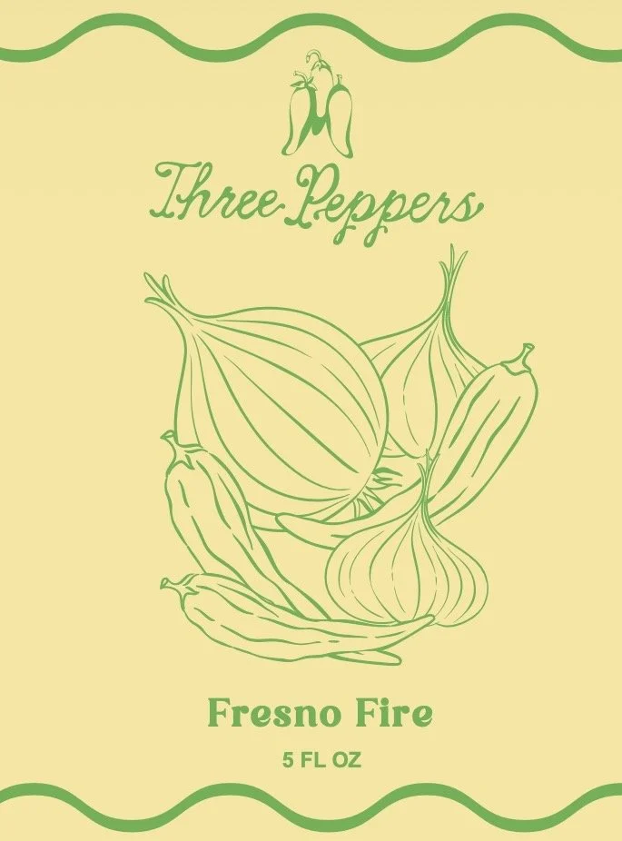 Packaging of Three Peppers Fresno Fire hot peppers in a 5 fluid ounce container, with illustrations of chili peppers and onions.