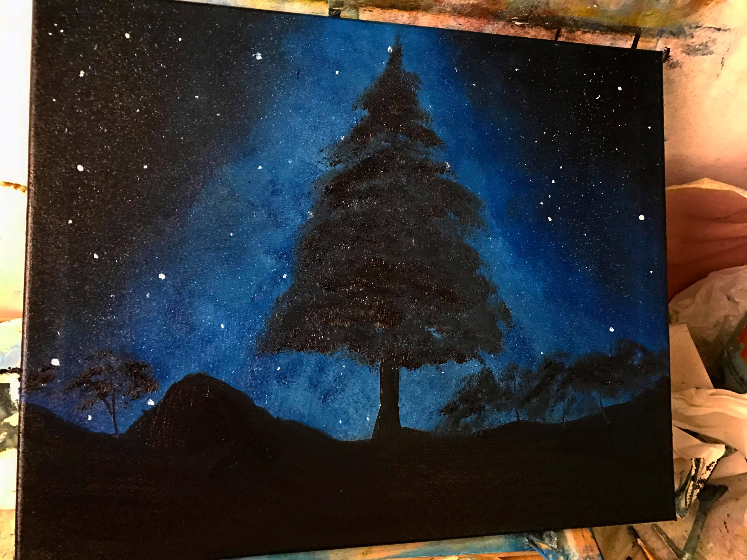 Nighttime landscape painting of a large pine tree on a hill under a starry sky, with shades of blue and black.