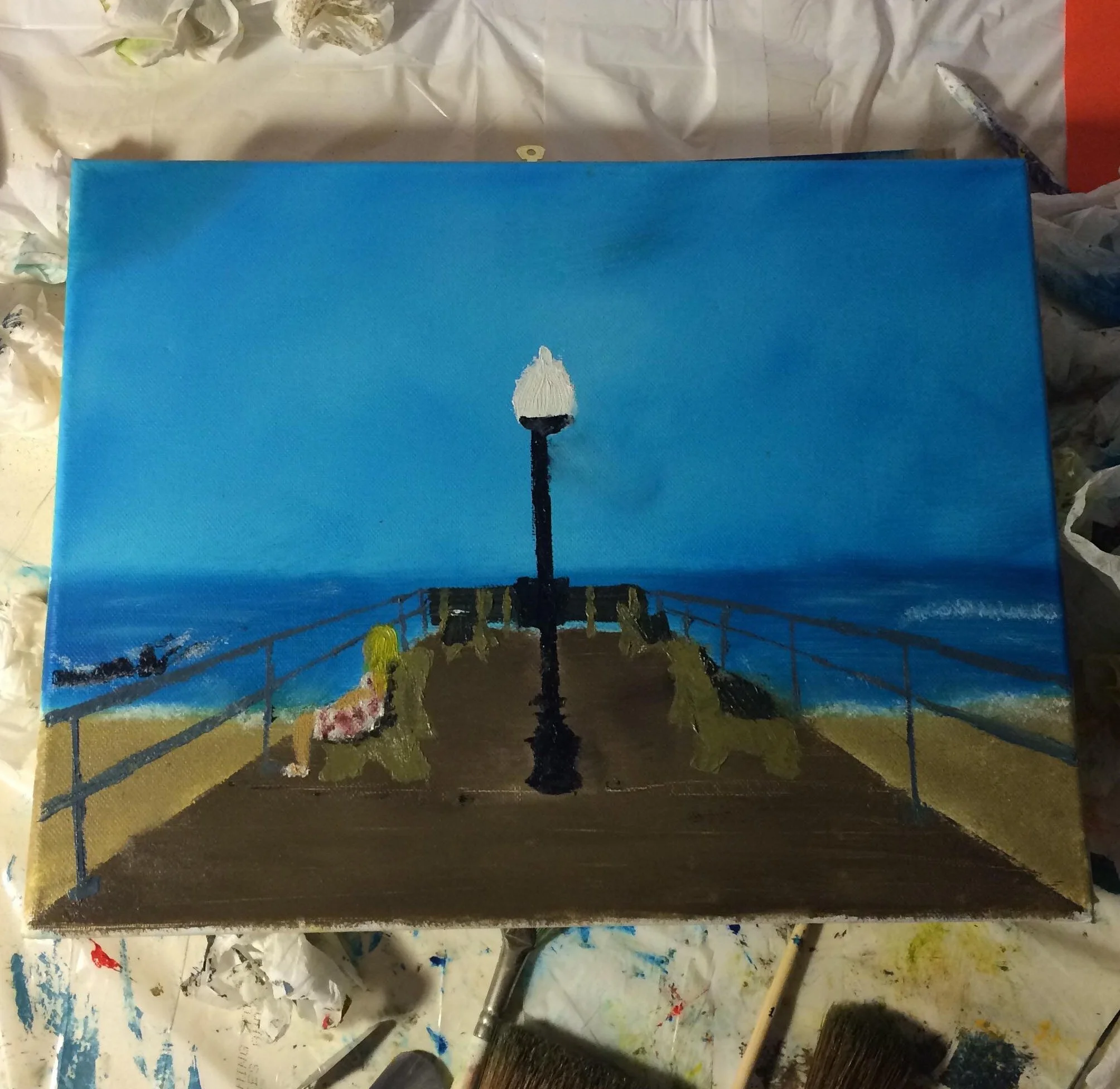 A painting of a pier extending toward the ocean under a clear blue sky, with a street lamp and benches on the pier, and two people sitting on the benches, one with a pink dress and the other with a yellow dress.