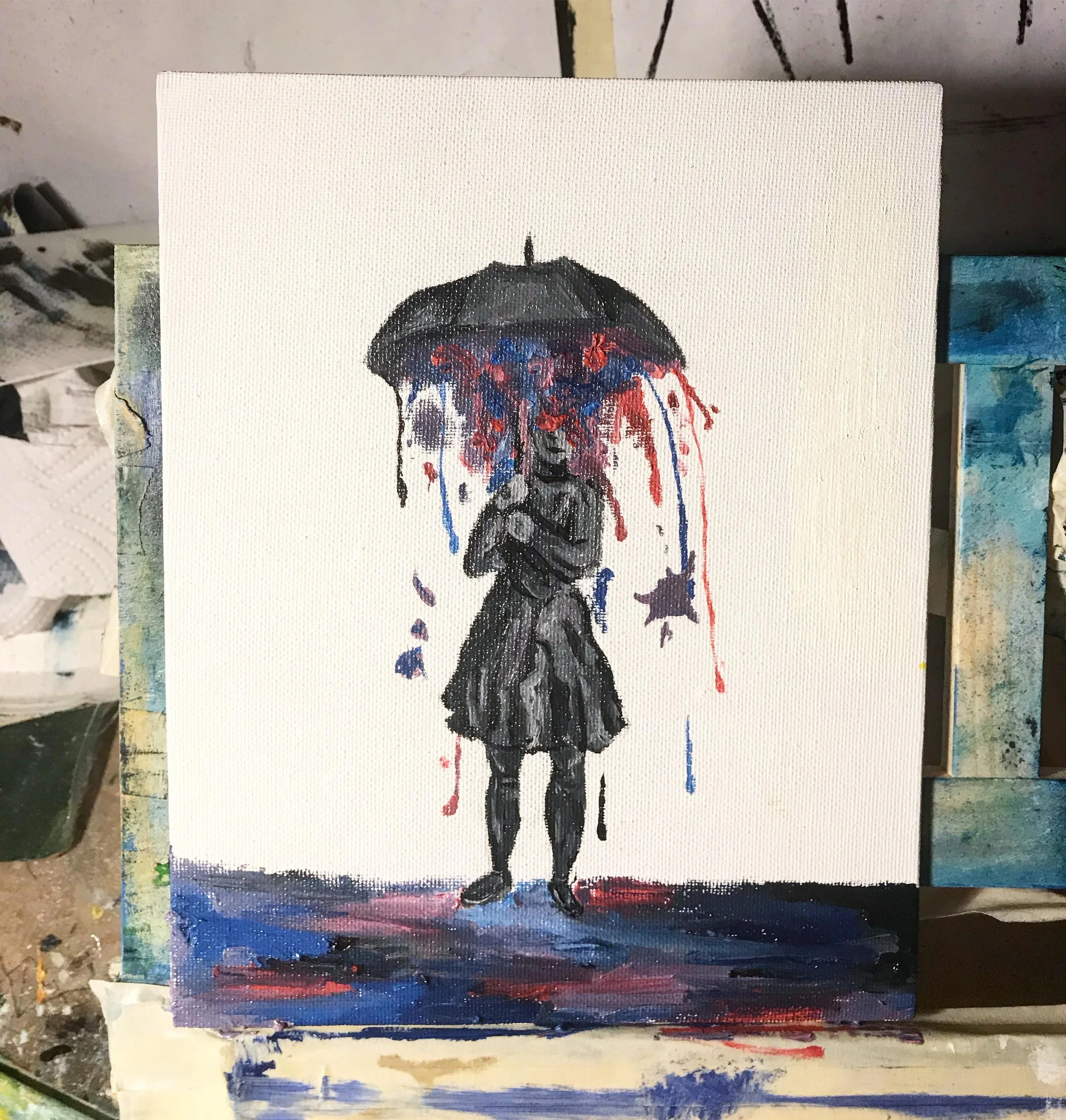 Painting of a girl holding an umbrella with red, blue, and purple paint drips, standing against a white background with colorful ground at her feet.