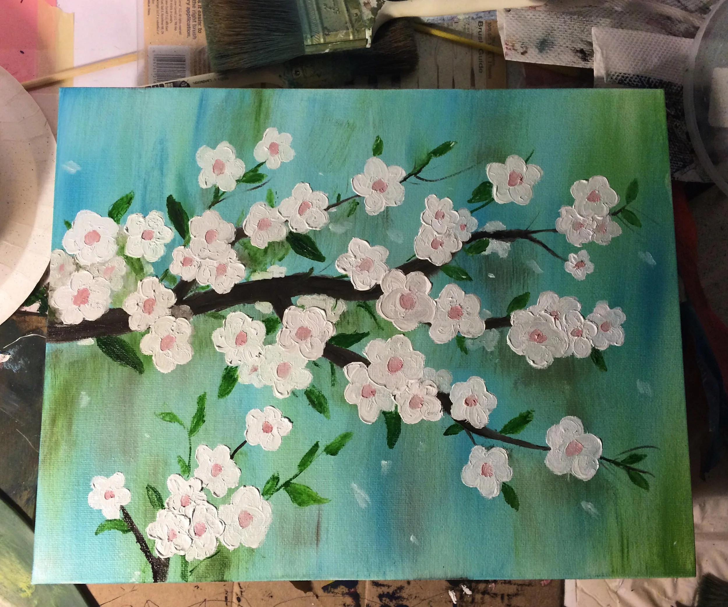 A painting of a cherry blossom tree branch with white flowers and pink centers, set against a blue and green background.