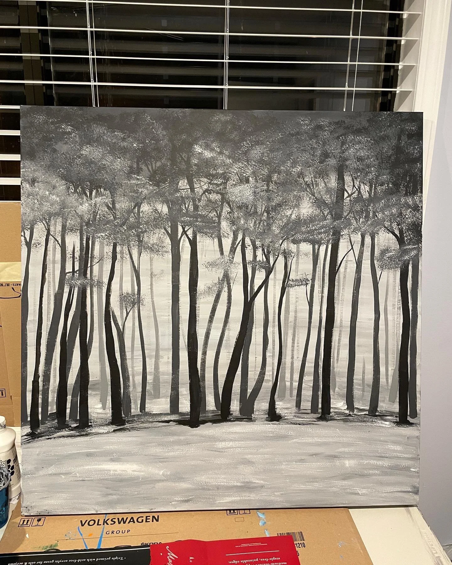 Black and white painting of a forest with tall, slender trees and a misty background.