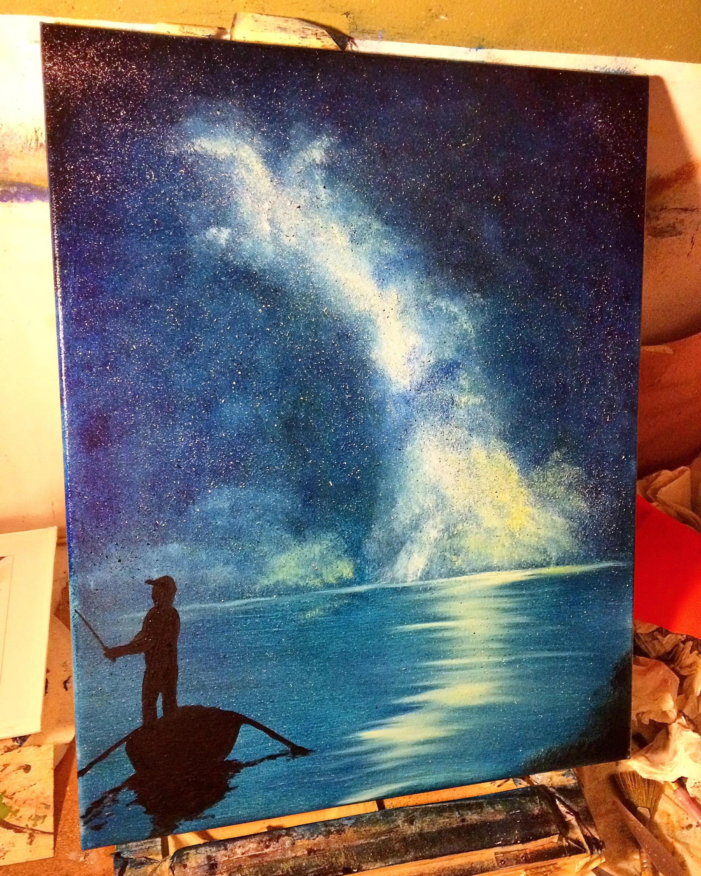 A silhouette of a person fishing on a small boat in calm water under a starry night sky with the Milky Way galaxy visible.