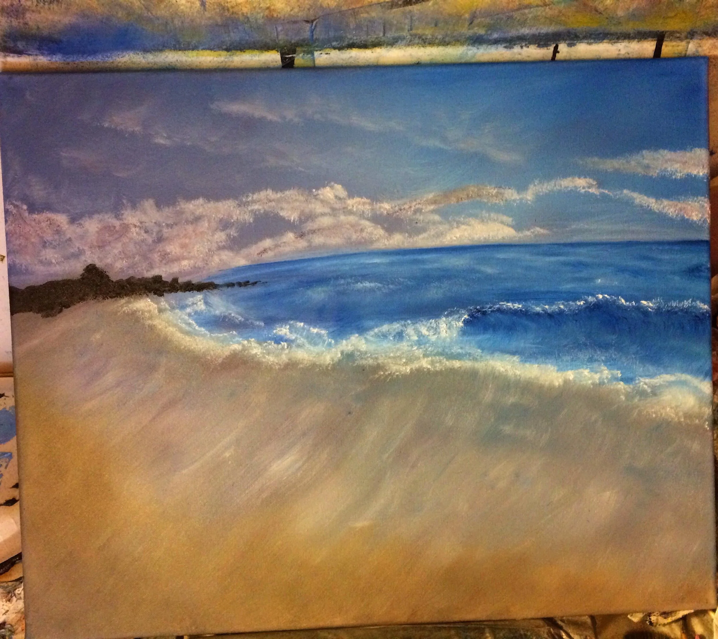 A painting of a beach scene with blue ocean waves, sandy shore, and sky with clouds.