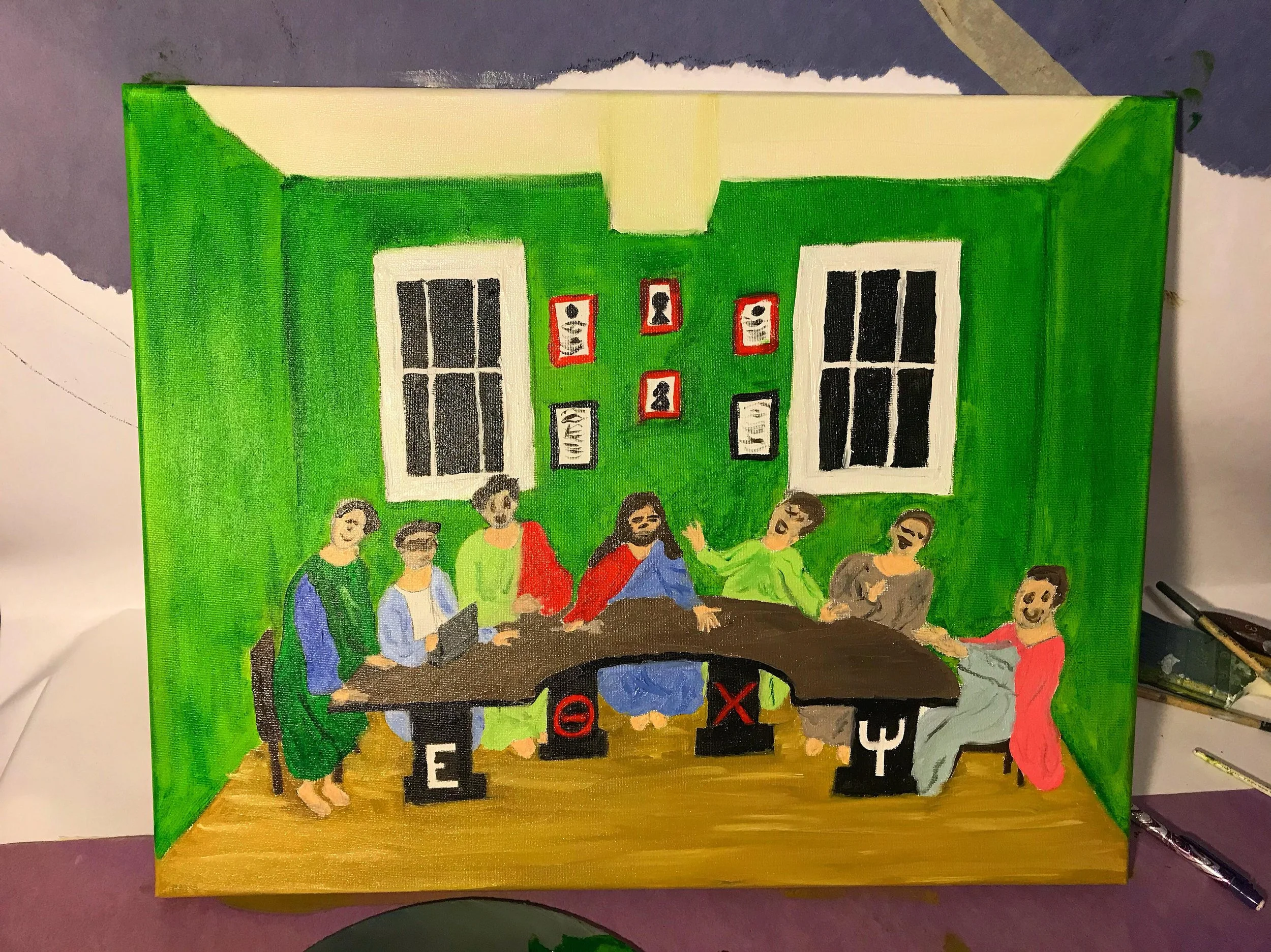 Colorful painting of The Last Supper with Jesus and his disciples, replacing traditional apostles with symbols: an E, and mathematical symbols, in a room with green walls and framed pictures.