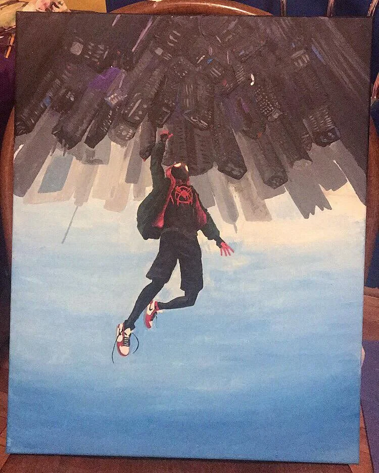 A person wearing a black hoodie with a red design, black shorts, and red-and-white sneakers appears to be falling from a cityscape upside down, with tall buildings above them and a blue sky below.