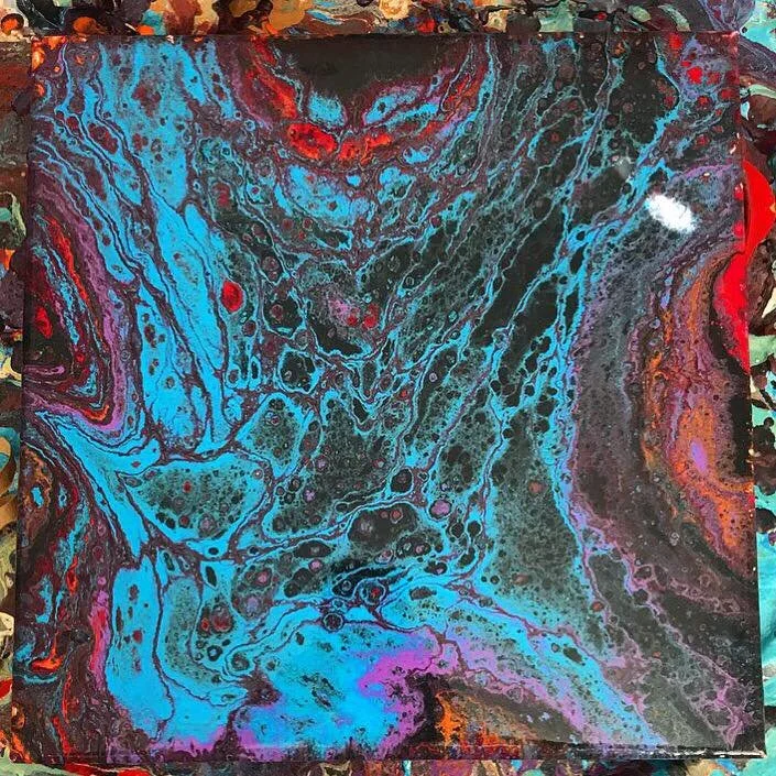 Abstract acrylic pour painting with swirling patterns of blue, black, purple, red, and orange colors.