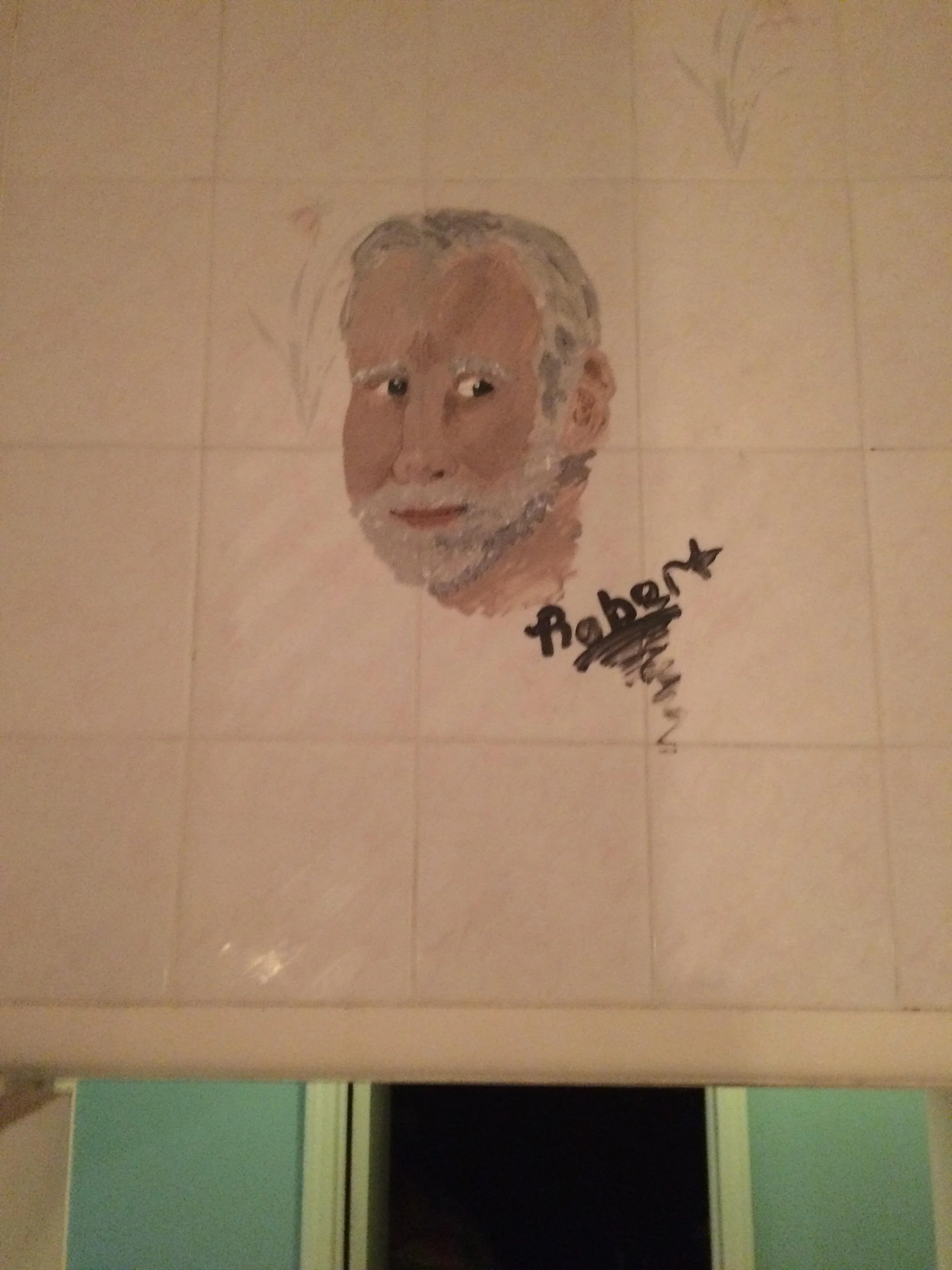 Hand-painted portrait of an elderly man with gray hair and beard on a tiled wall, with the name Roben written below.