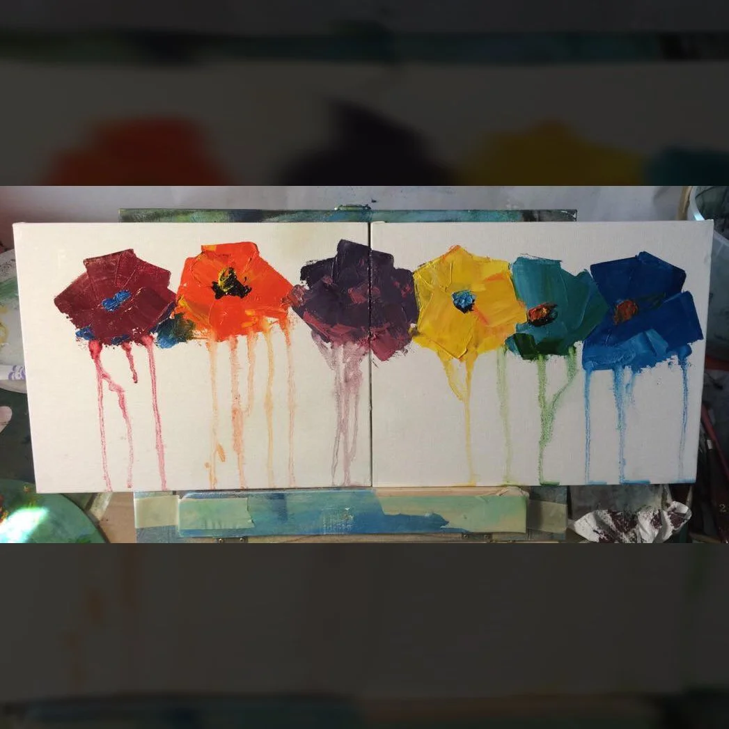 A colorful abstract painting of six umbrellas in red, orange, purple, yellow, green, and blue, with paint drips running down the canvas.