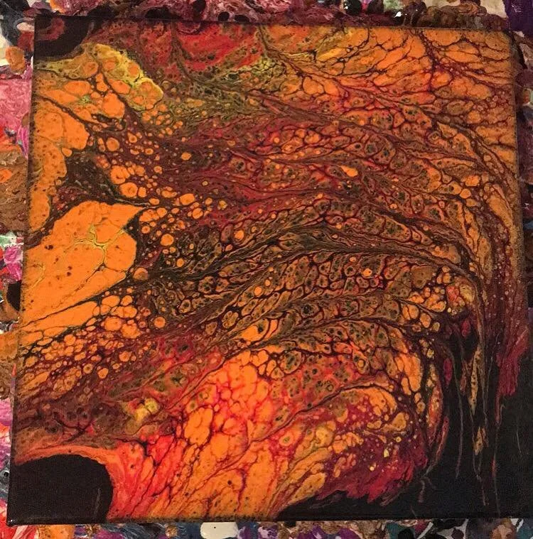Abstract painting with orange, yellow, red, and black swirling patterns and cell-like structures.