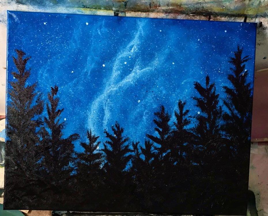 A painting of a night sky with stars and a galaxy above black silhouette pine trees.