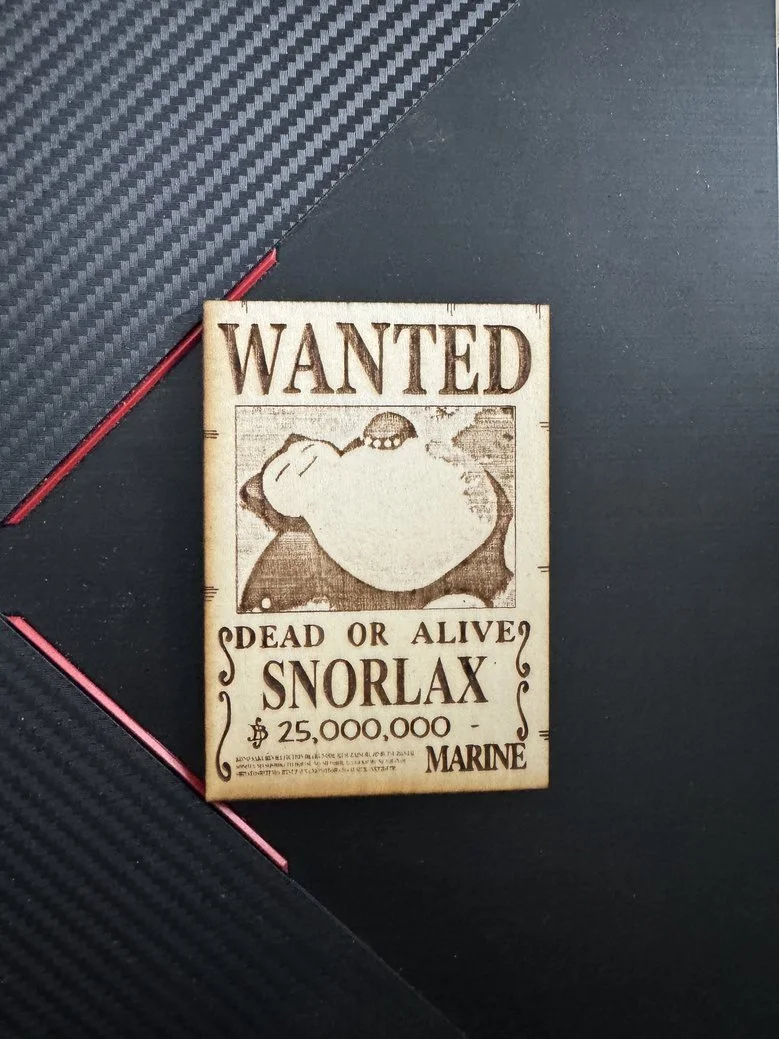 A wanted poster for a creature called Snorlax, depicting a large, sleeping animal with a round body, with a bounty of $25 million, issued by Marine authorities.