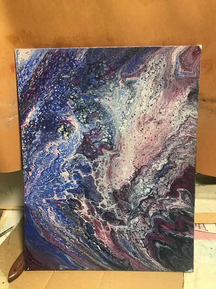 Abstract painting with swirling patterns of blue, pink, white, and black colors.