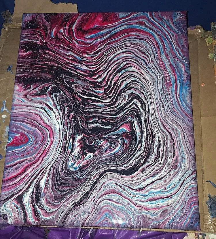 Abstract swirl painting with black, white, pink, purple, and blue colors, creating a marbled effect.