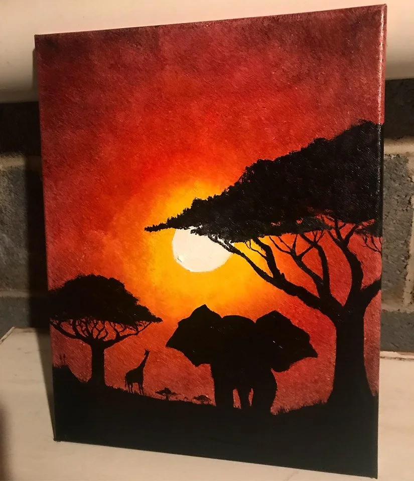 Silhouette of trees, giraffe, and elephant against a sunset with a red-orange sky and a large white sun.