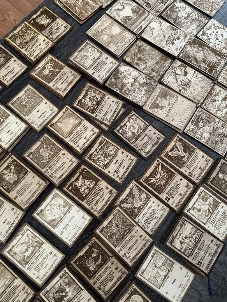 A collection of Pokémon trading cards laid out on a table.