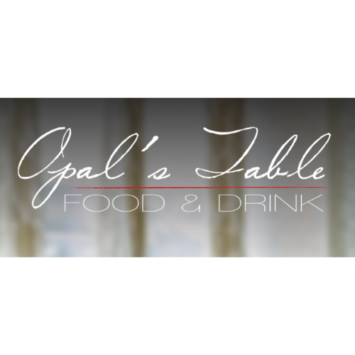 Sign reading 'Opal's Table Food & Drink' with a blurred background of curtains or drapes.