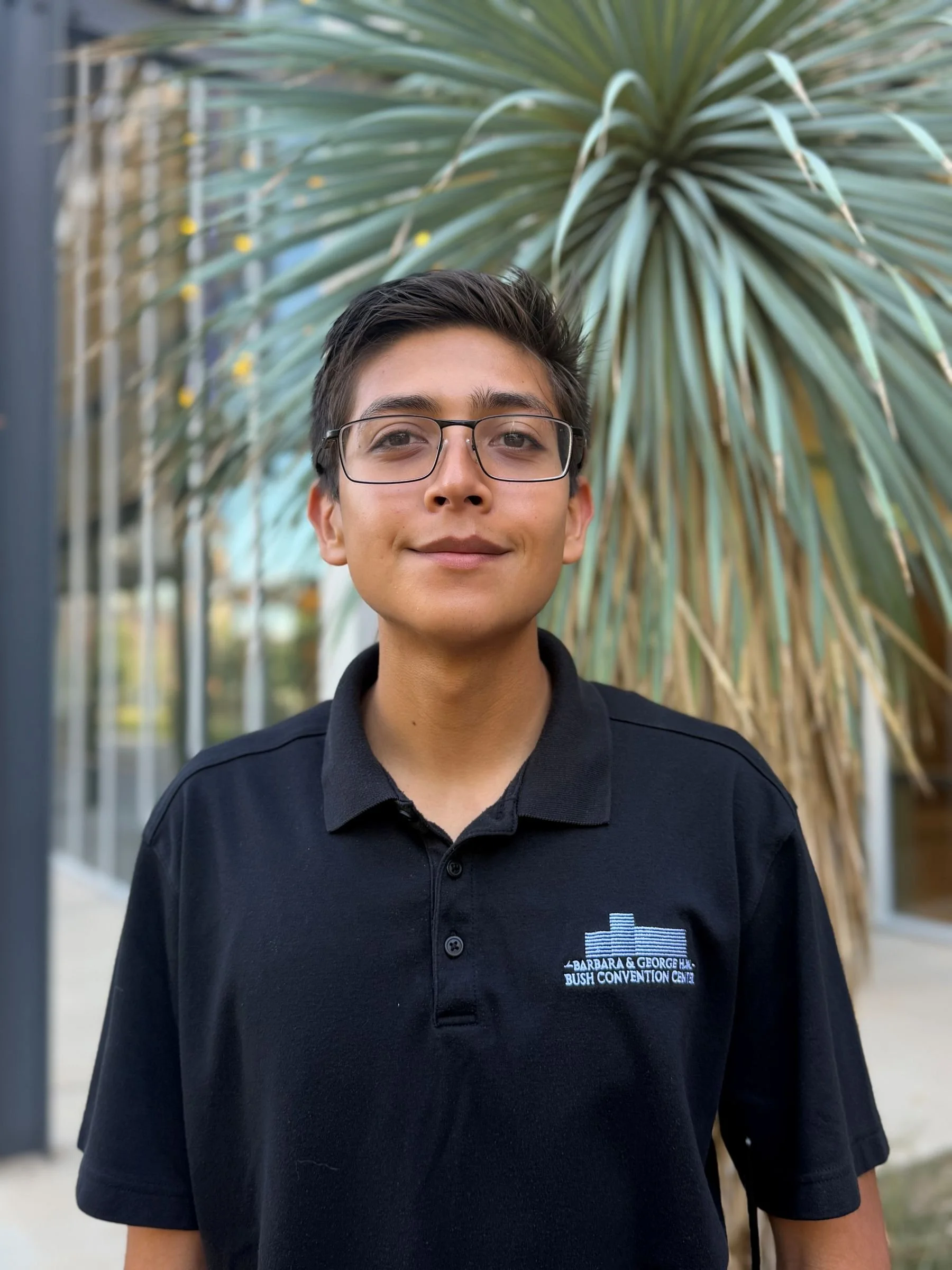 Man with black shirt brown hair and glasses