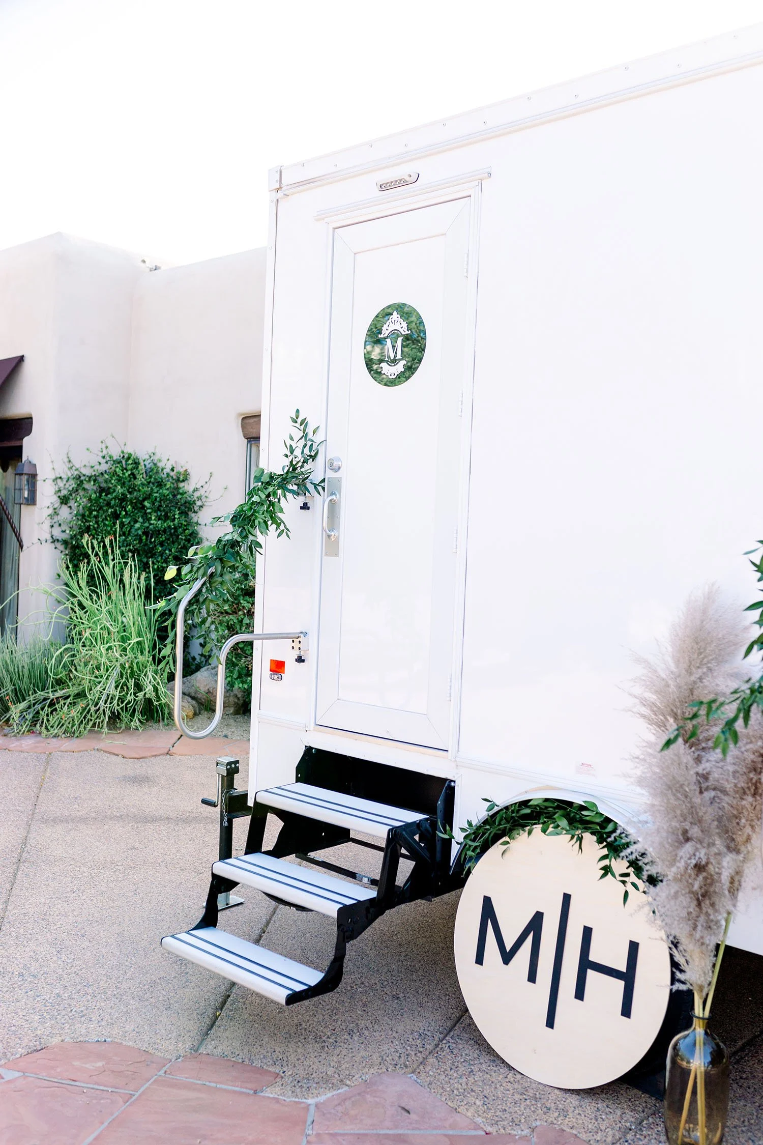 exterior of a restroom trailer for a scottsdale wedding with couples initial decor