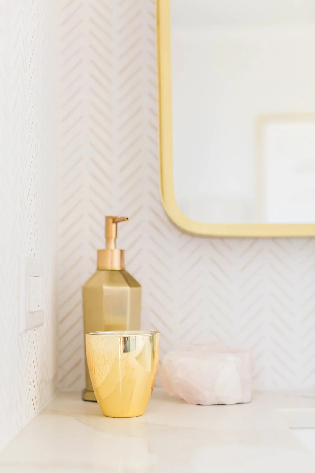 gold accents and decor inside of a portable powder room