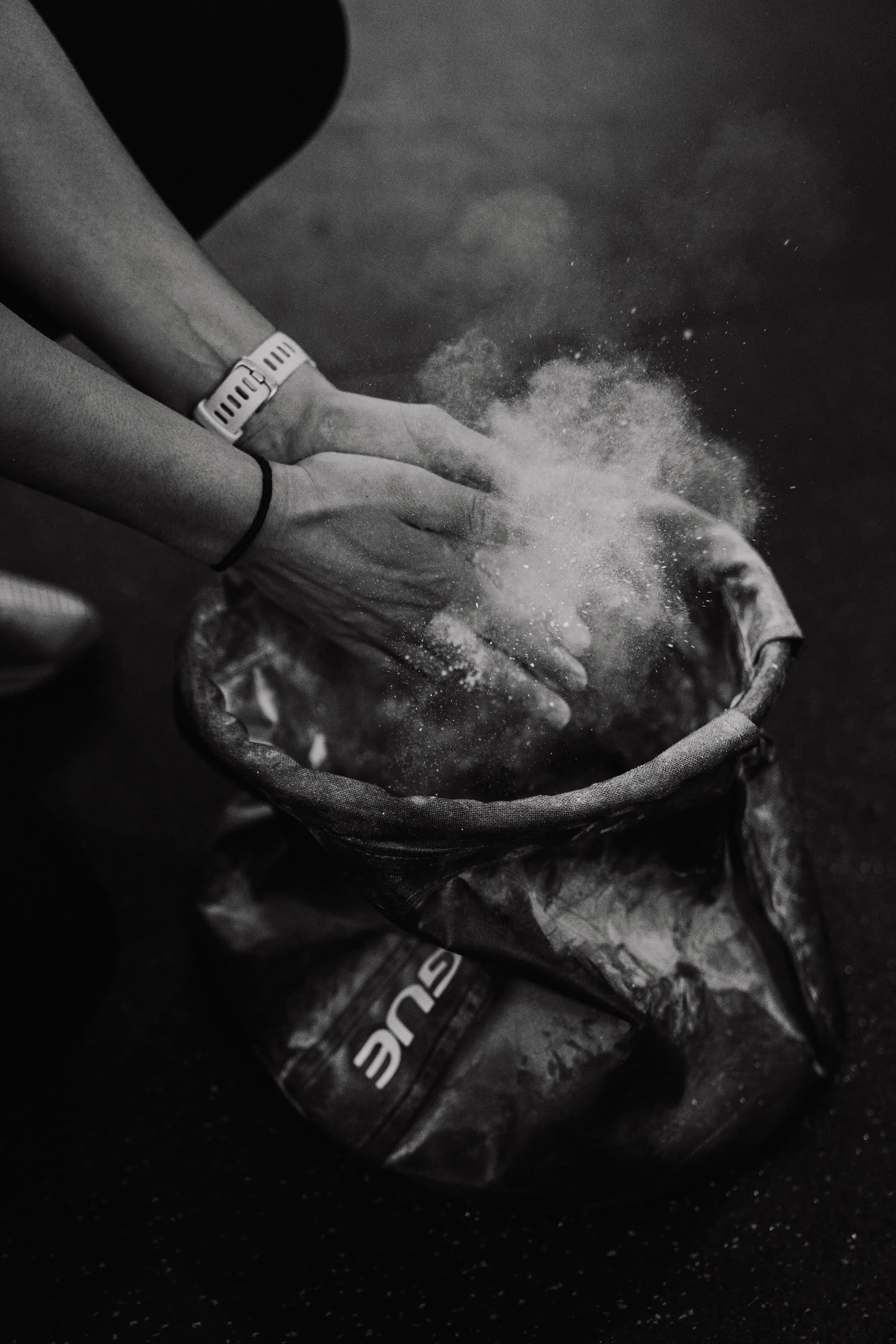 Person mixing powder in a bag.