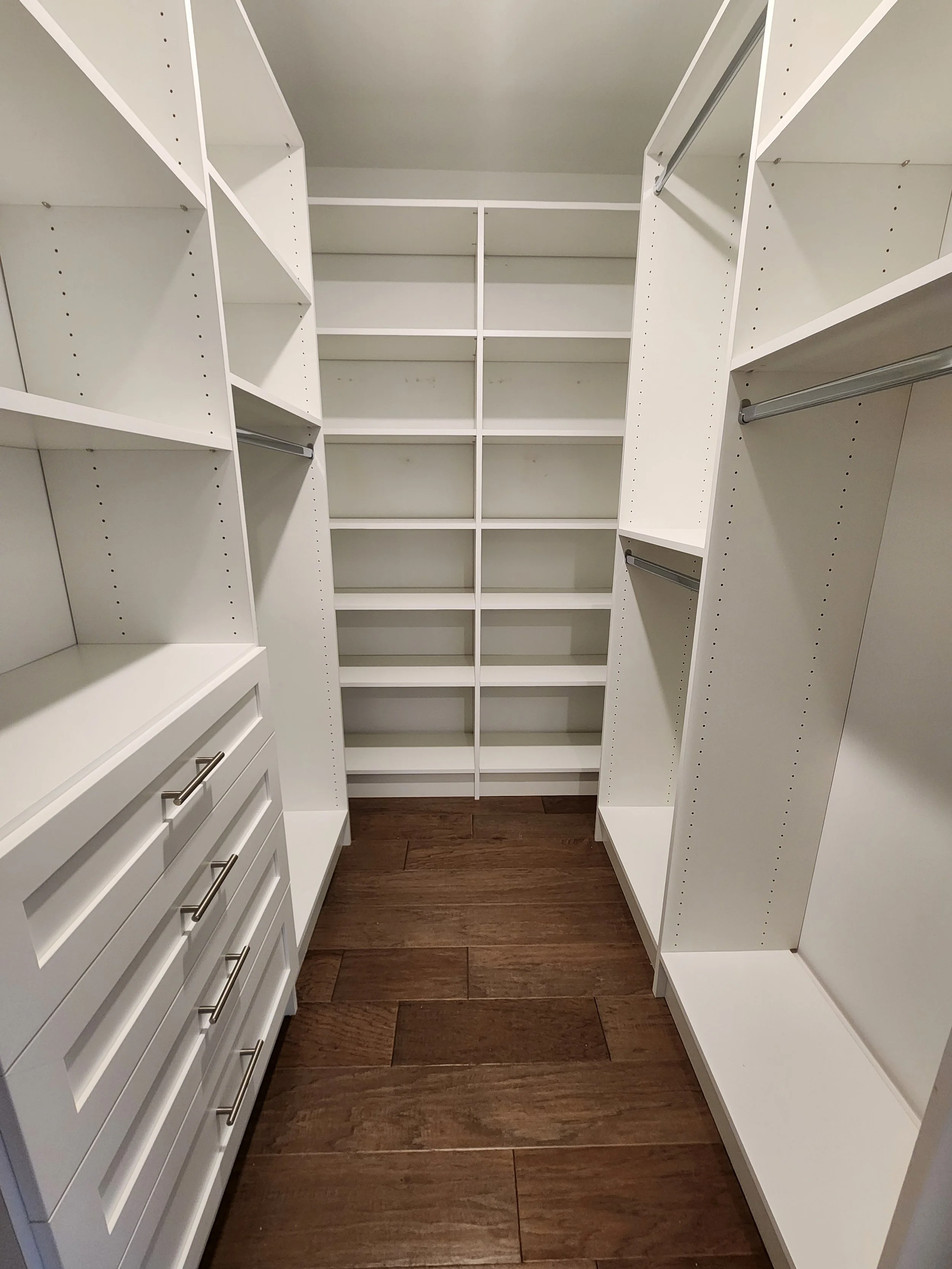 Whippany Primary Closet Walk In with 1 set of drawers with shaker style and shelving on the back wall