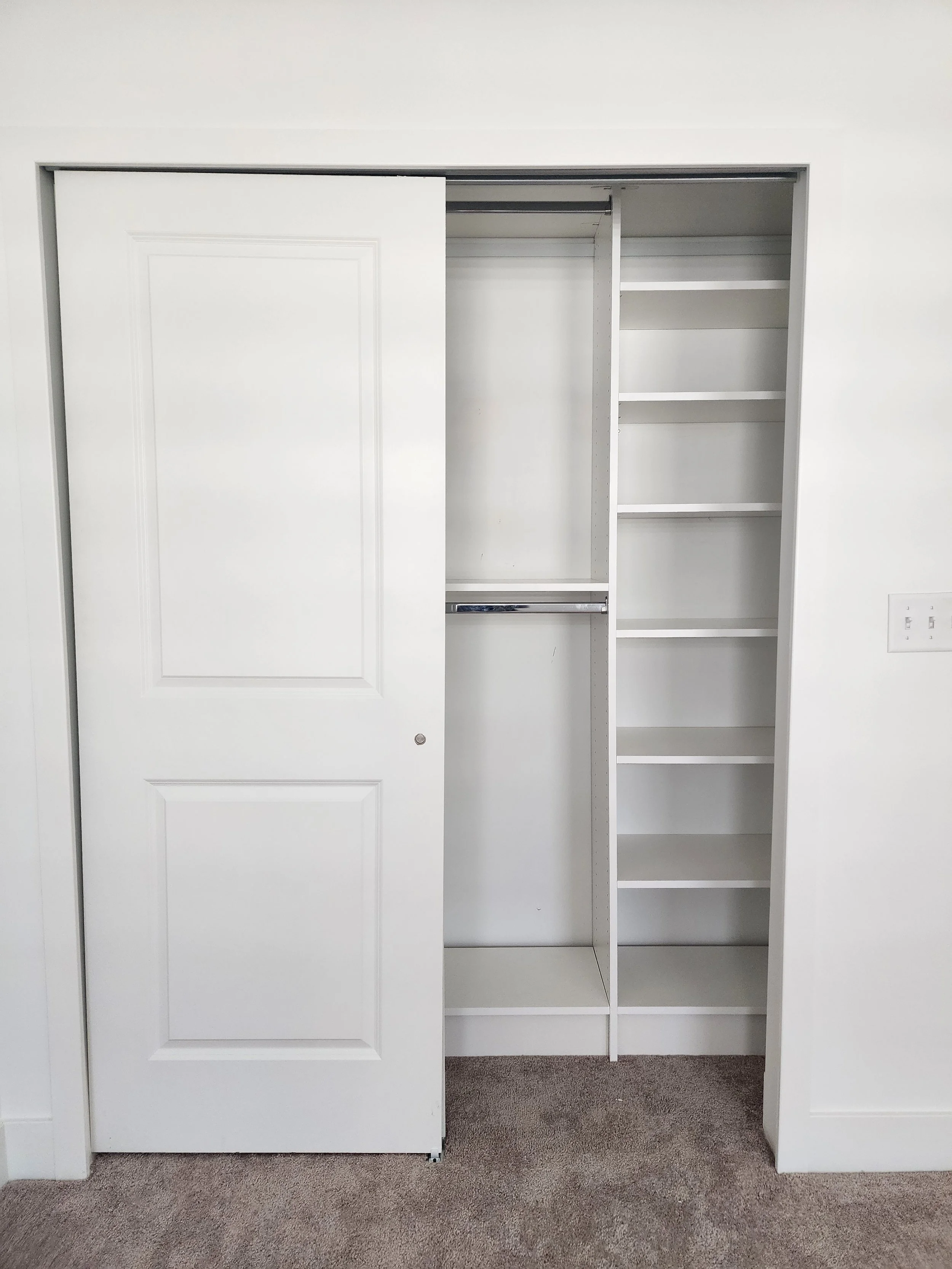 White Reach In Closet with bi pass doors