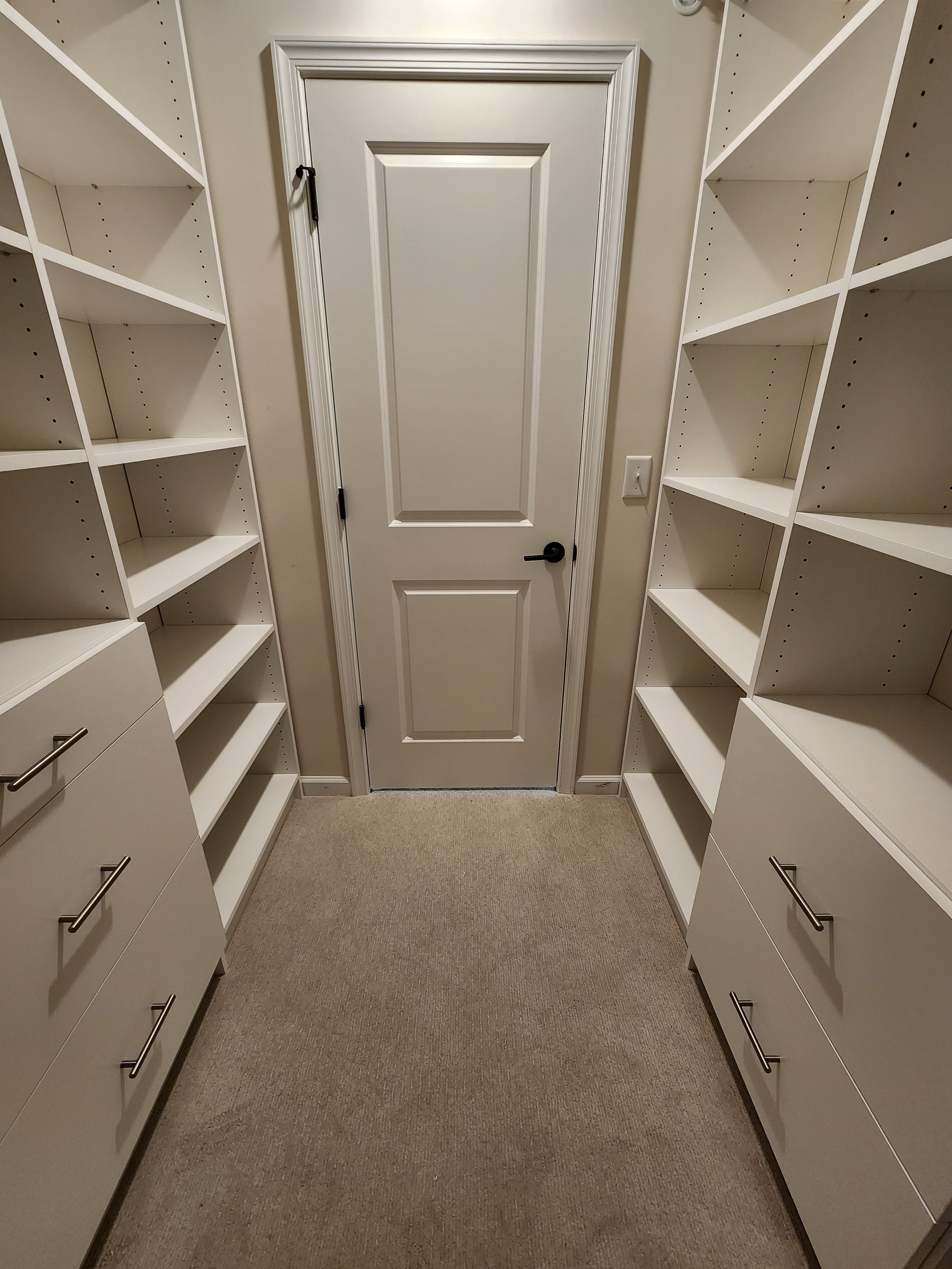 Another view of the custom closet showcasing smooth faced drawers
