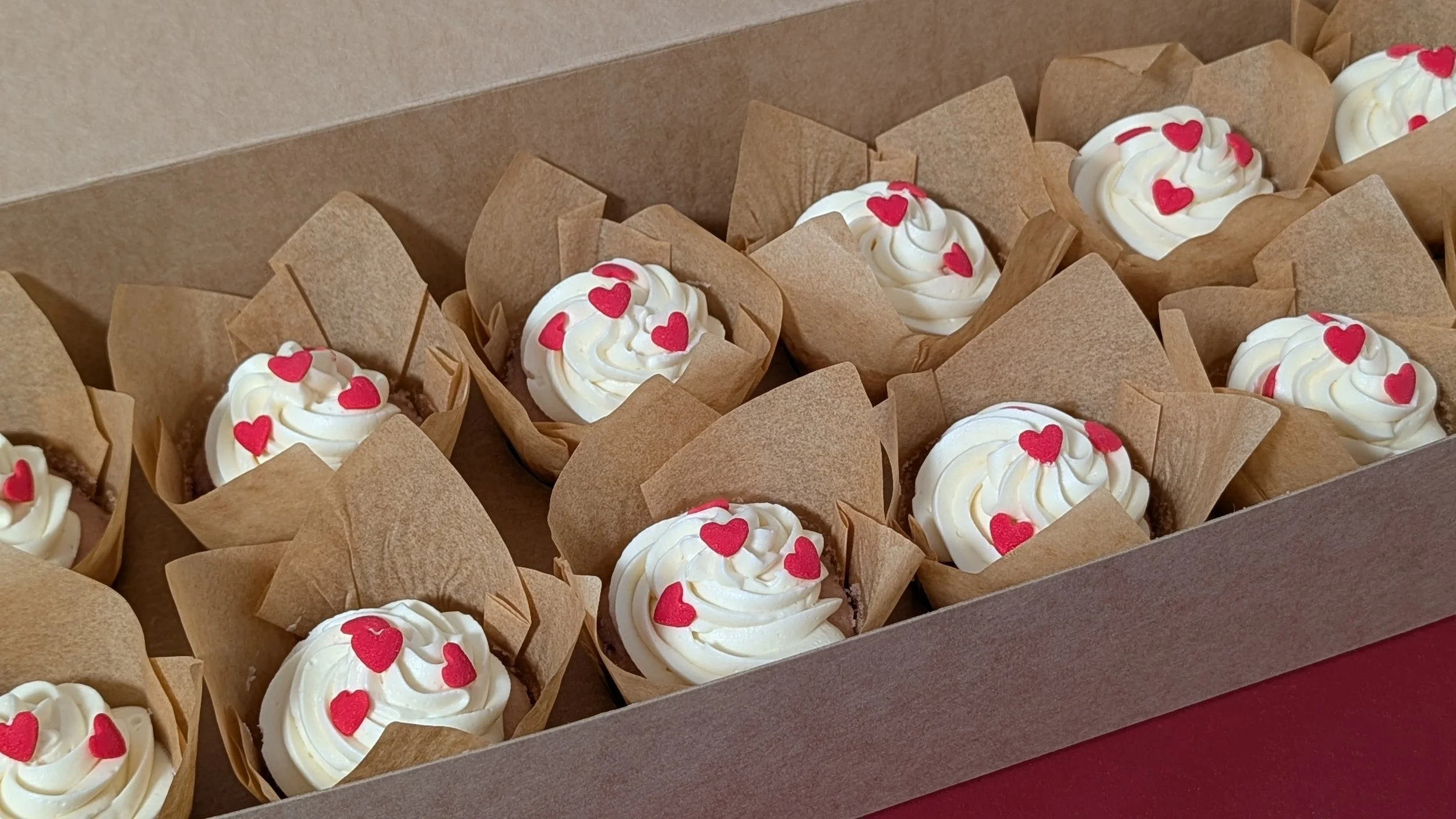 12 strawberry cupcakes in a box