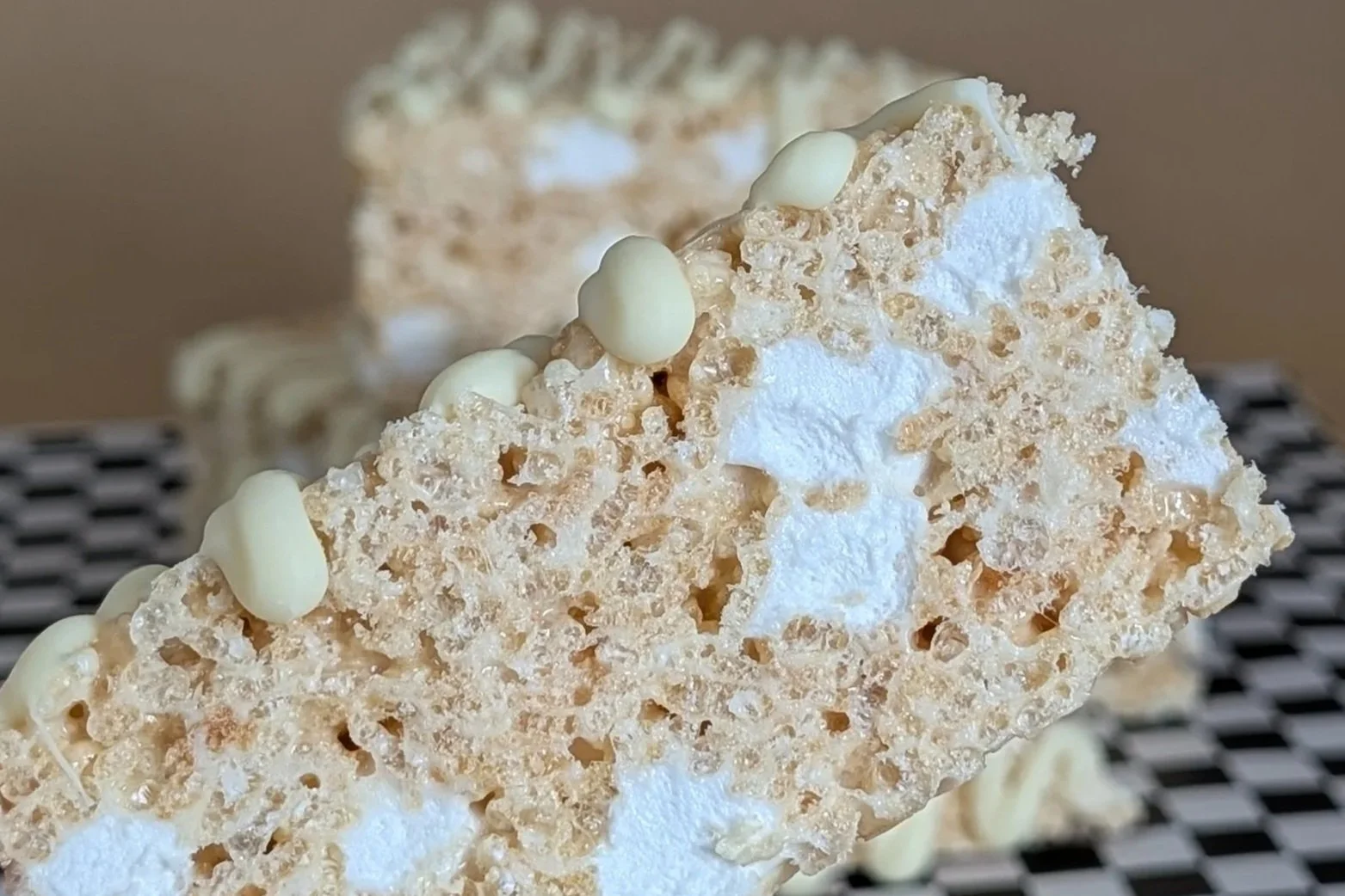 Close up of side of rice krispy treat with white chocolate drizzle (Copy)