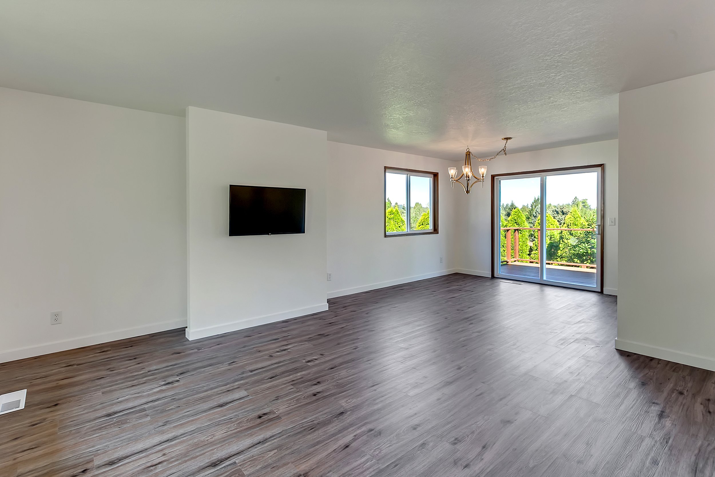 "Before" photo of an empty living room prior to being virtually staged