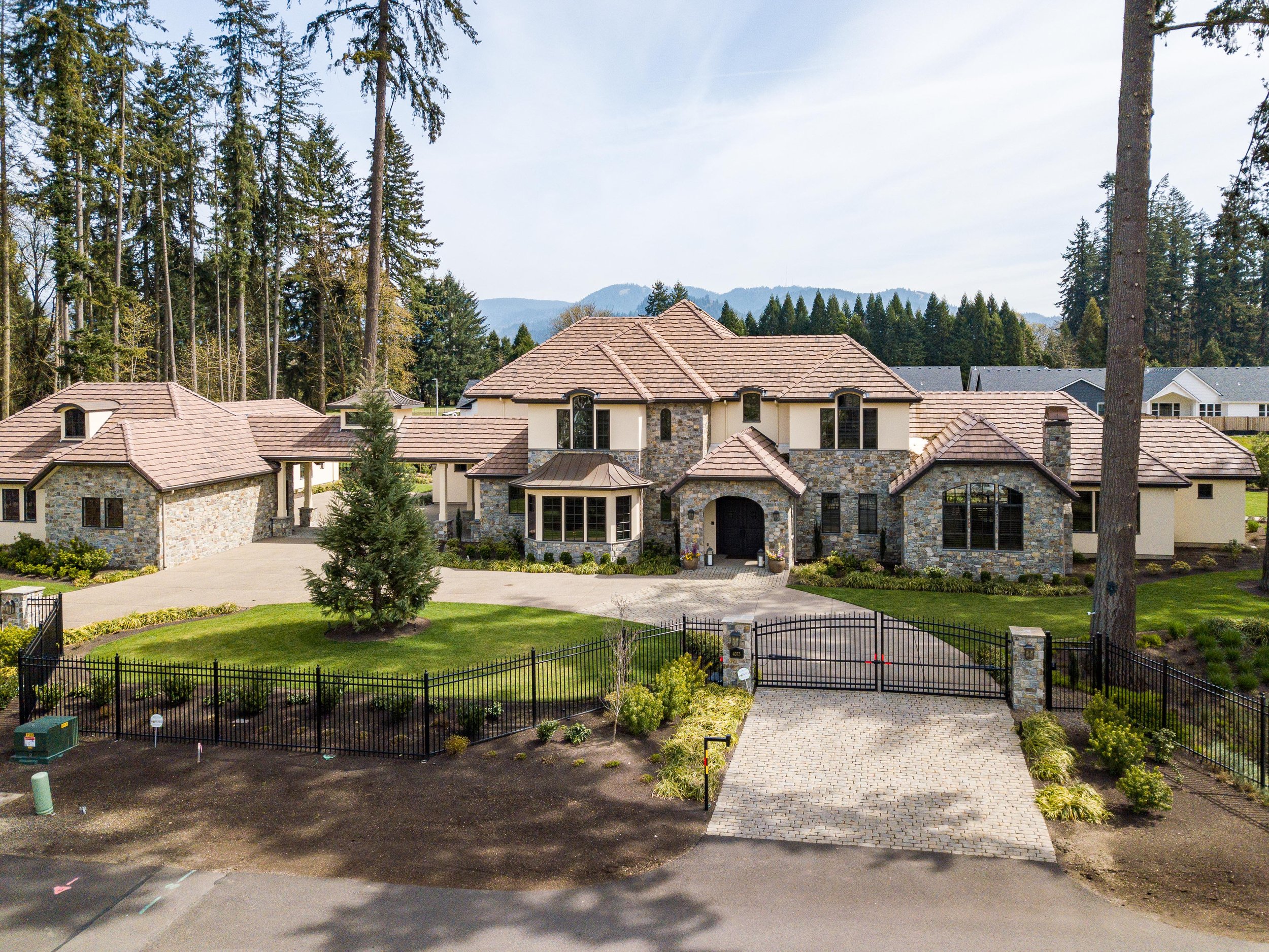 Grand Northwest villa exterior with manicured landscape