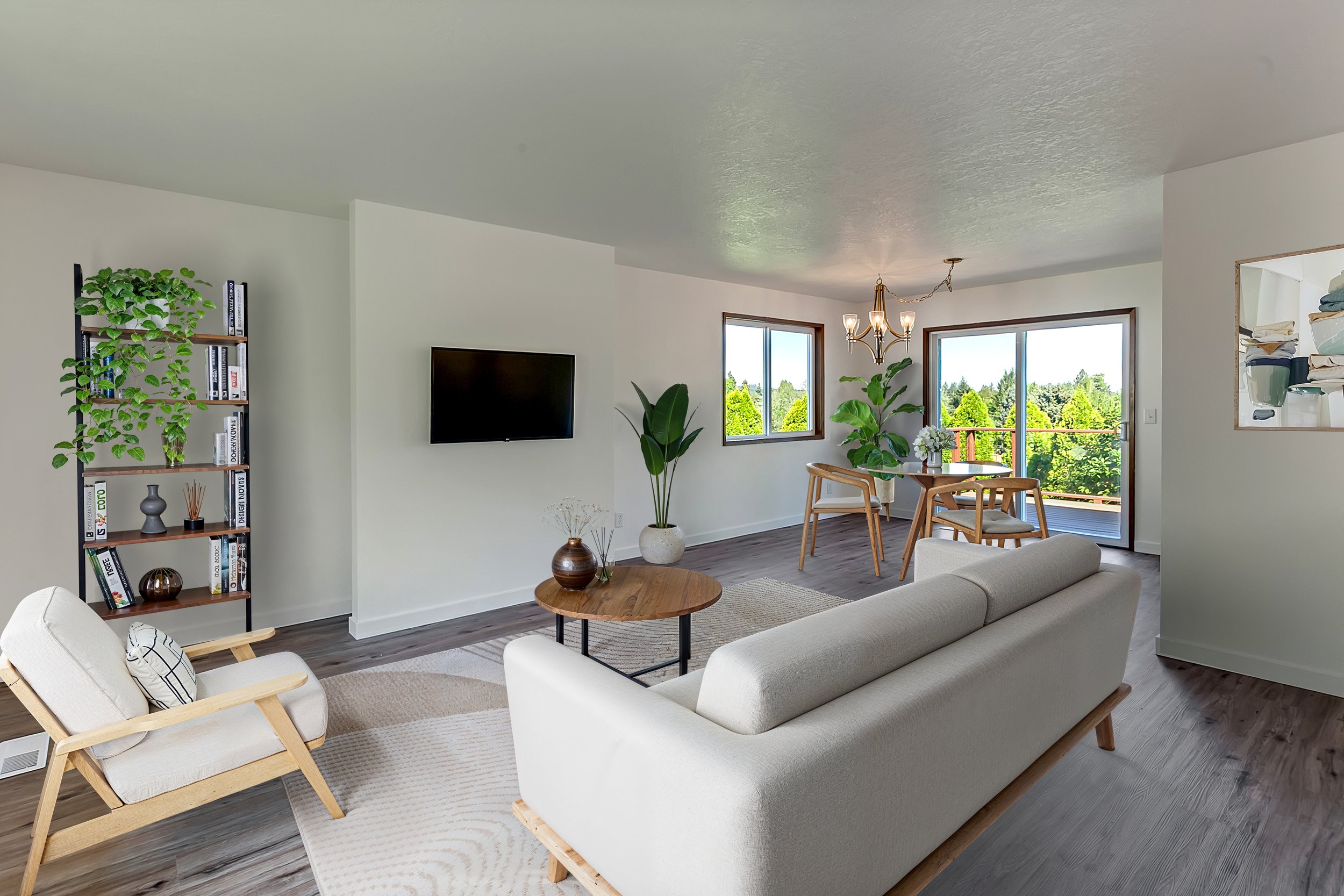 Virtually staged "after" photo of a living room featuring modern furniture and greenery