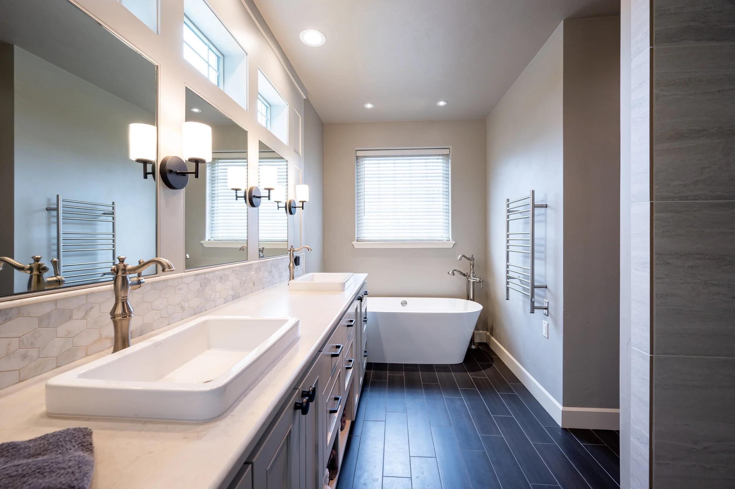Primary bathroom with soaking tub, window, and modern fixtures