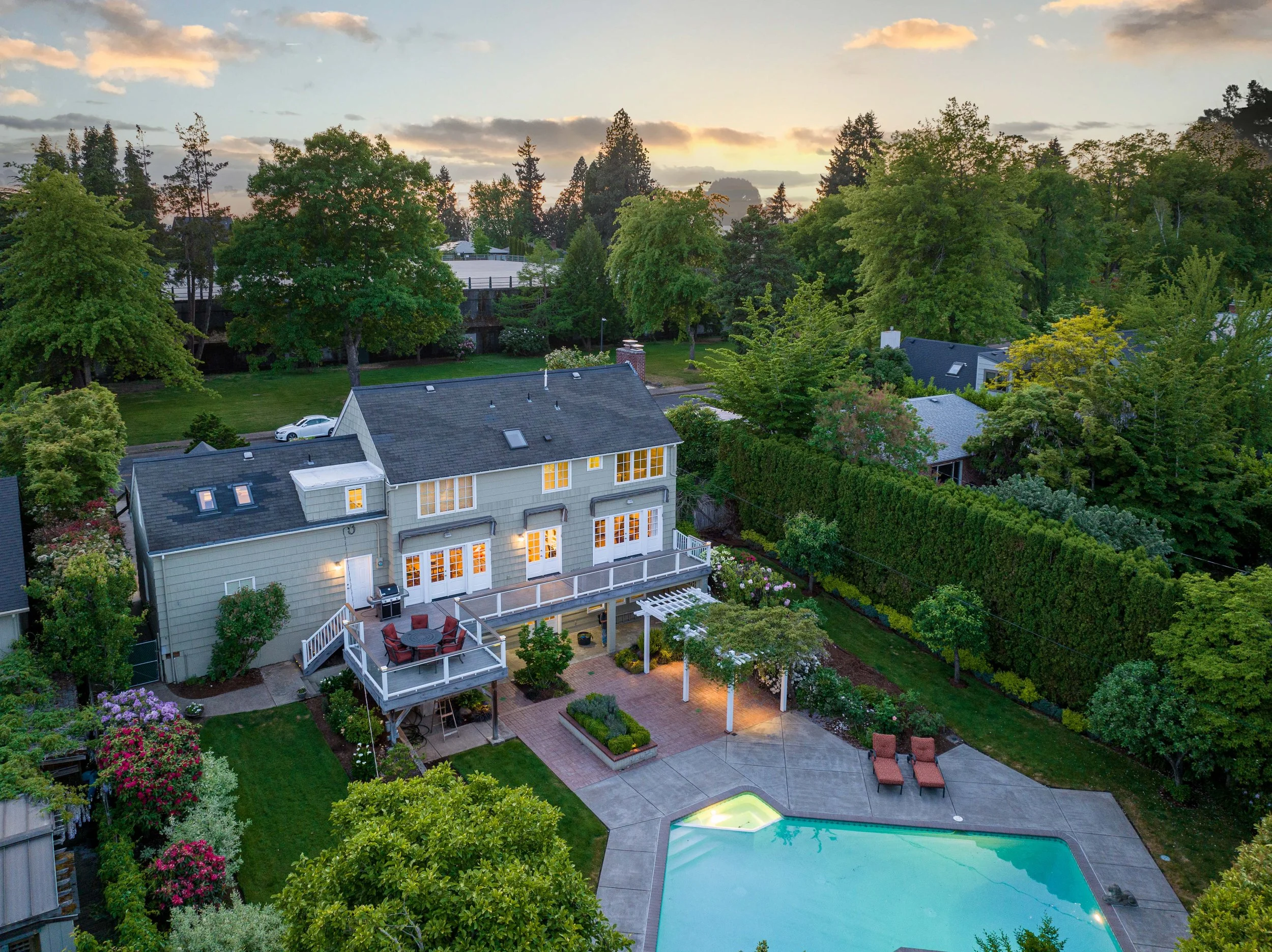 Twilight drone photography of a Portland home with landscaped backyard and pool for real estate marketing