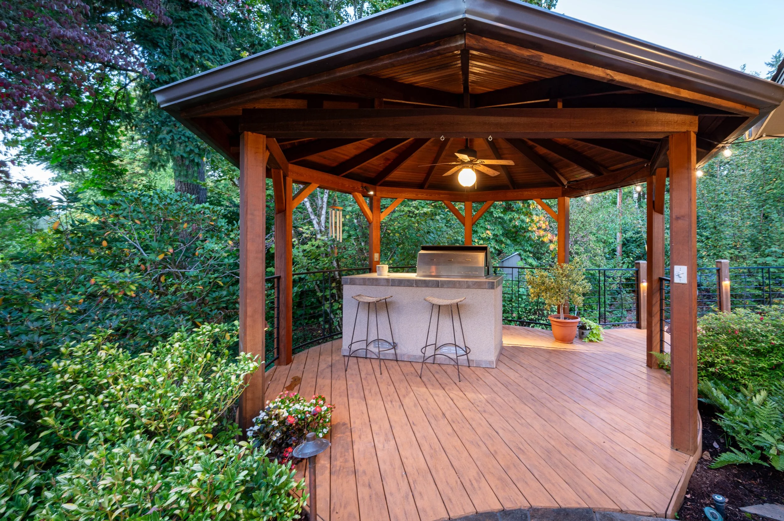 Covered outdoor pavilion with bar seating and wood ceiling
