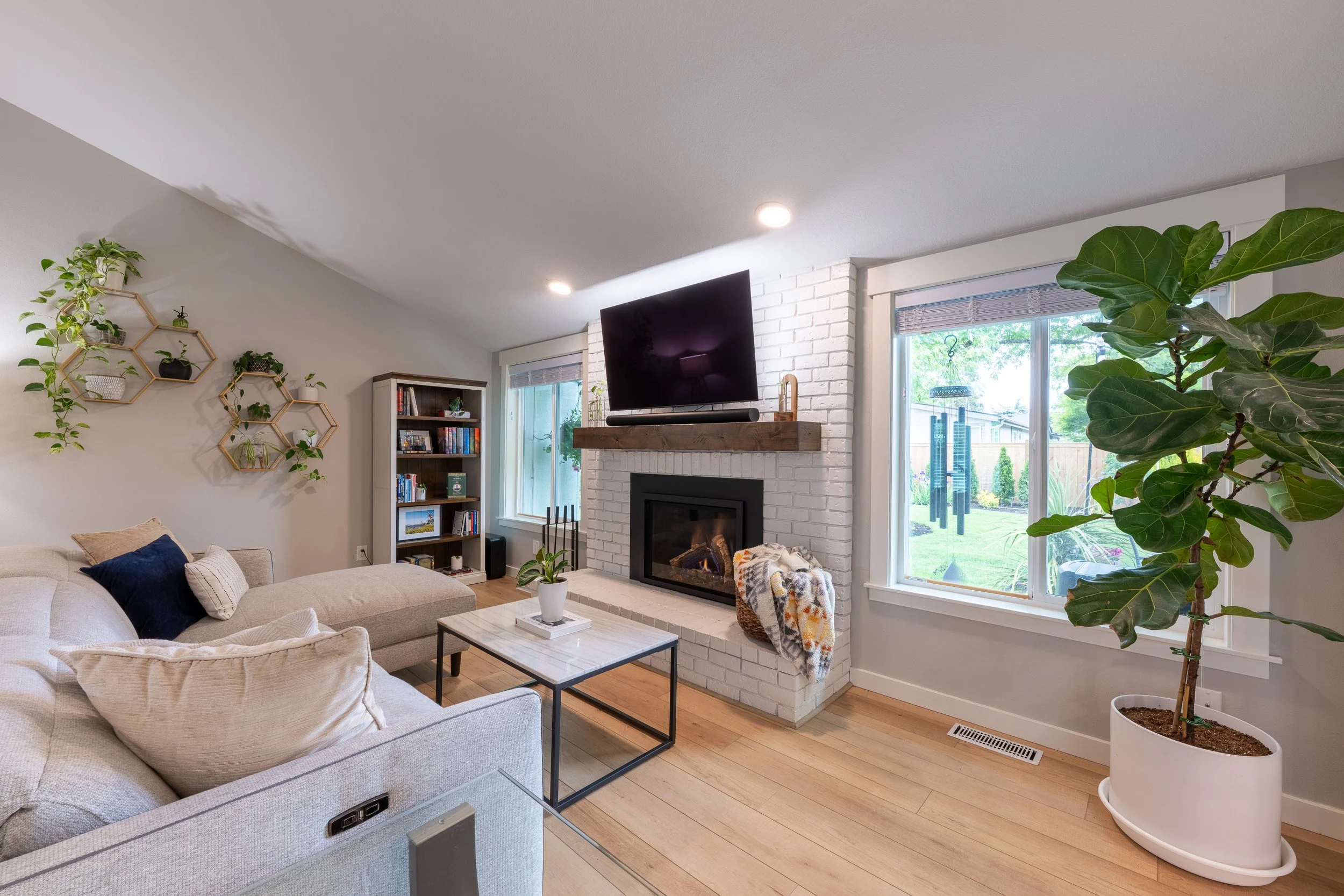 Living room view with fireplace, mounted television, and seating area