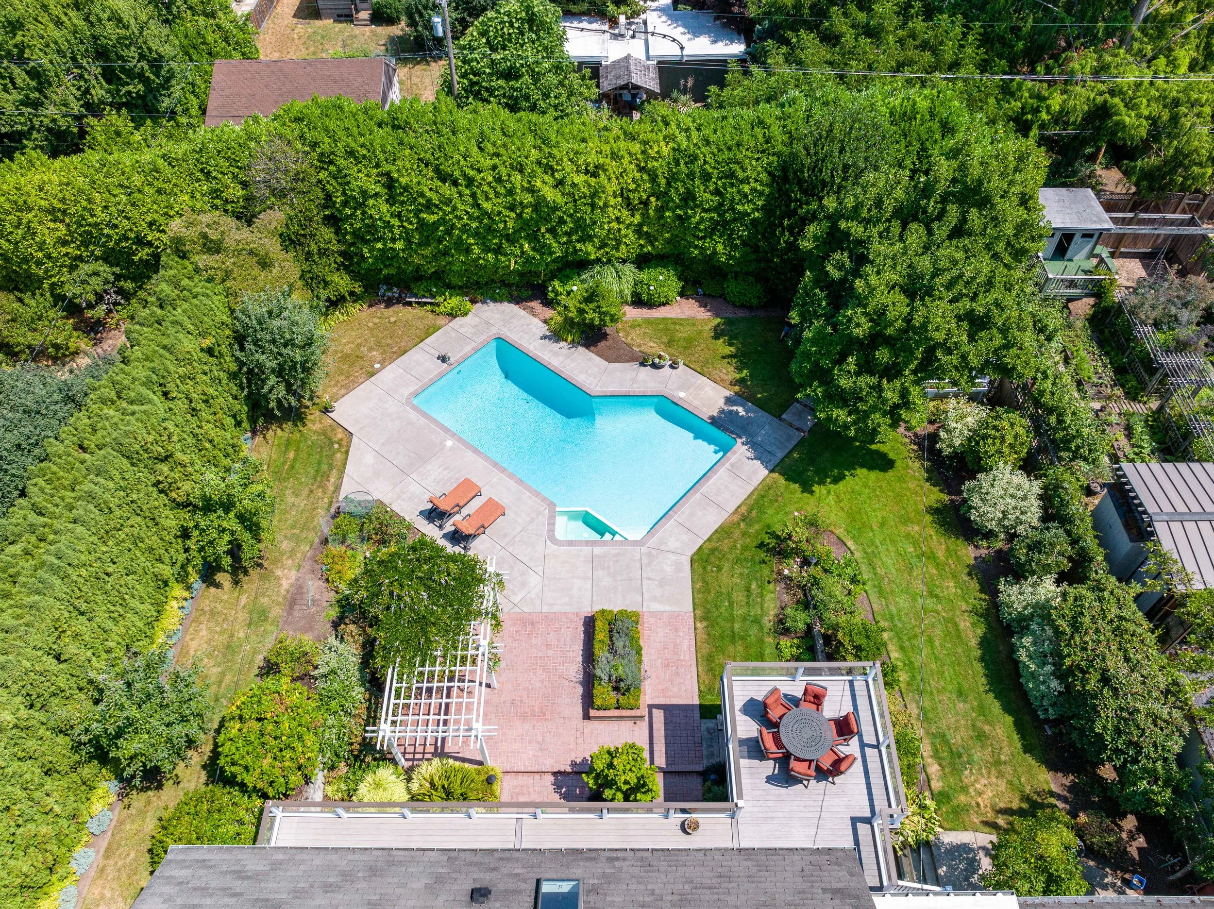 Top-down aerial view of backyard pool and patio area