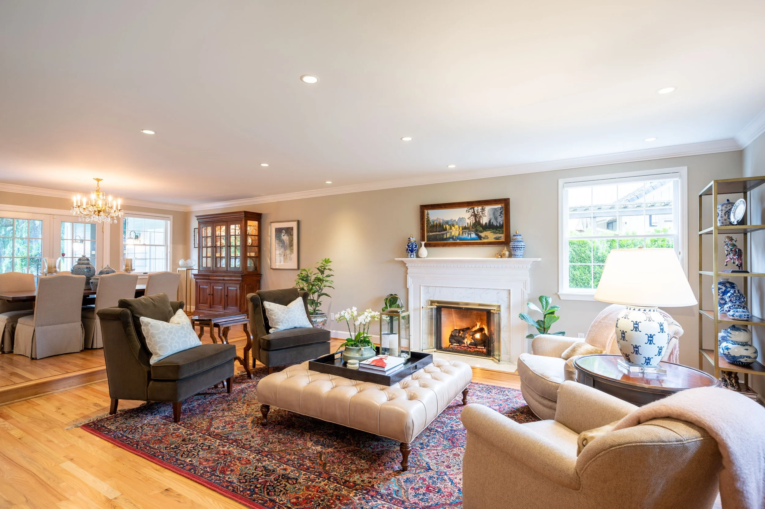 Living room with fireplace, hardwood floors, and large seating area
