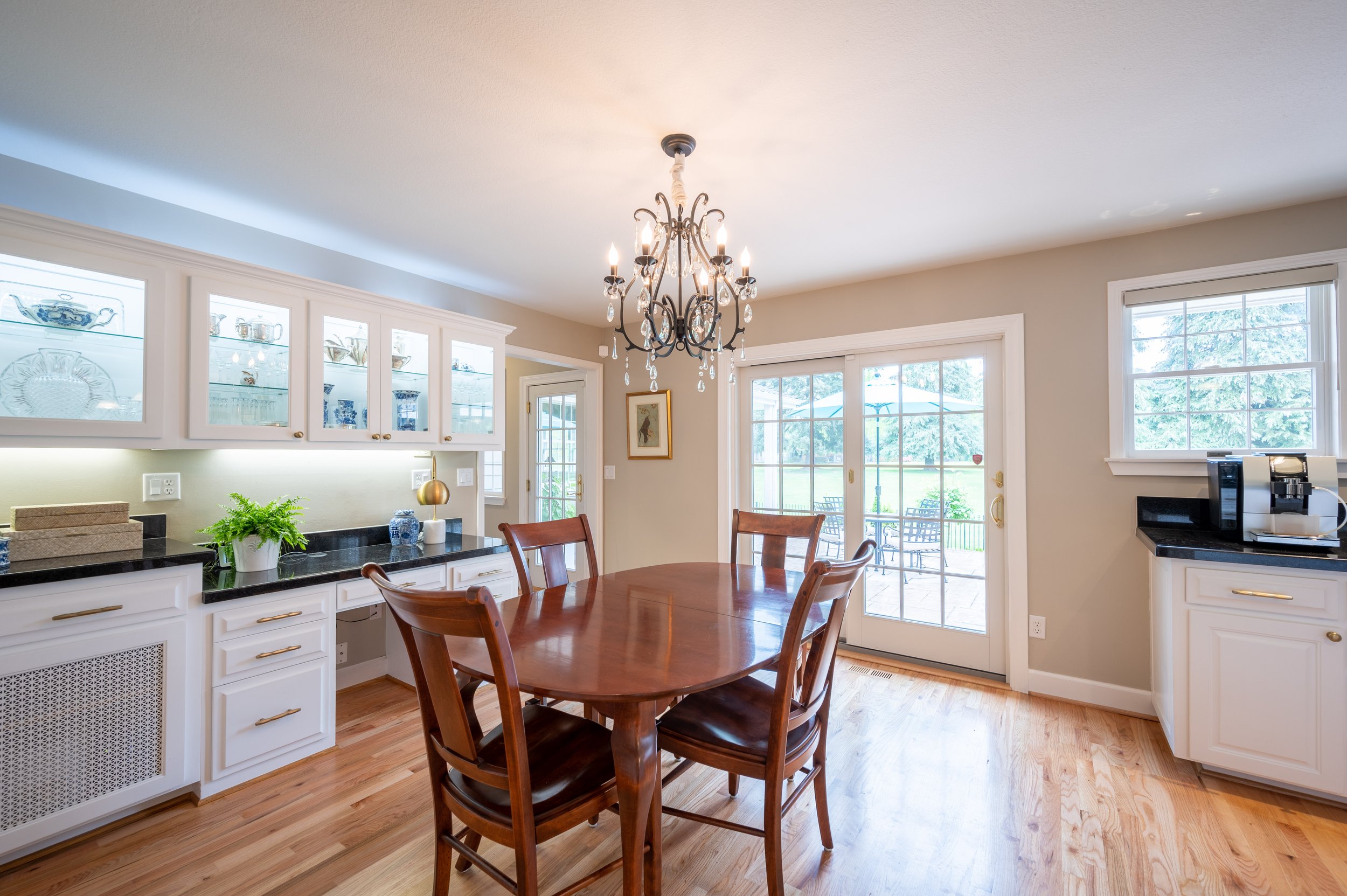 Dining room with chandelier, hardwood floors, and garden views
