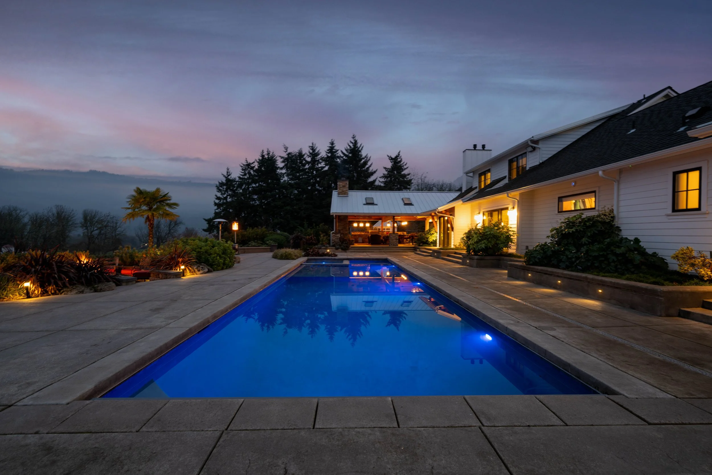 Twilight view of luxury pool and surrounding landscape